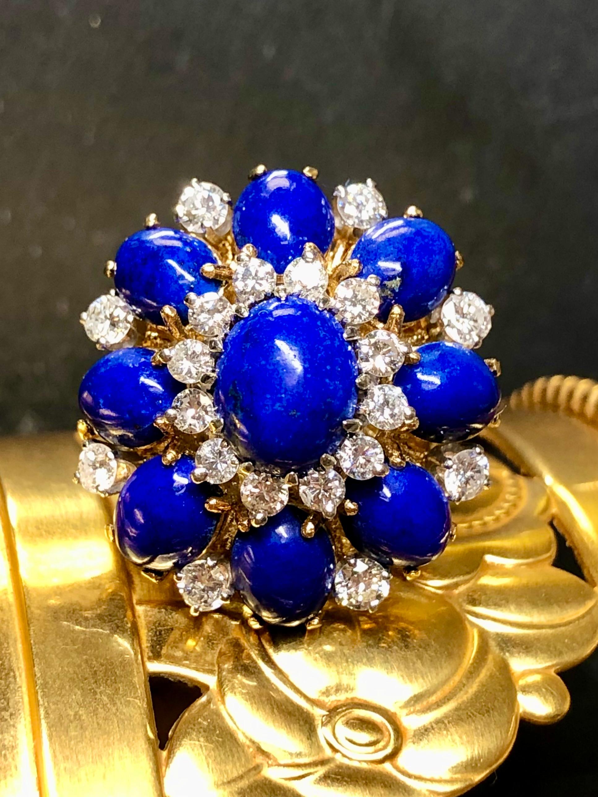 This truly is the quintessential 1960’s bombé cocktail dome ring. Done in 18K yellow gold, this ring has been set with large lapis cabochons separated by approximately 1.40cttw in larger size round diamonds with all stones ranging G-H in color and