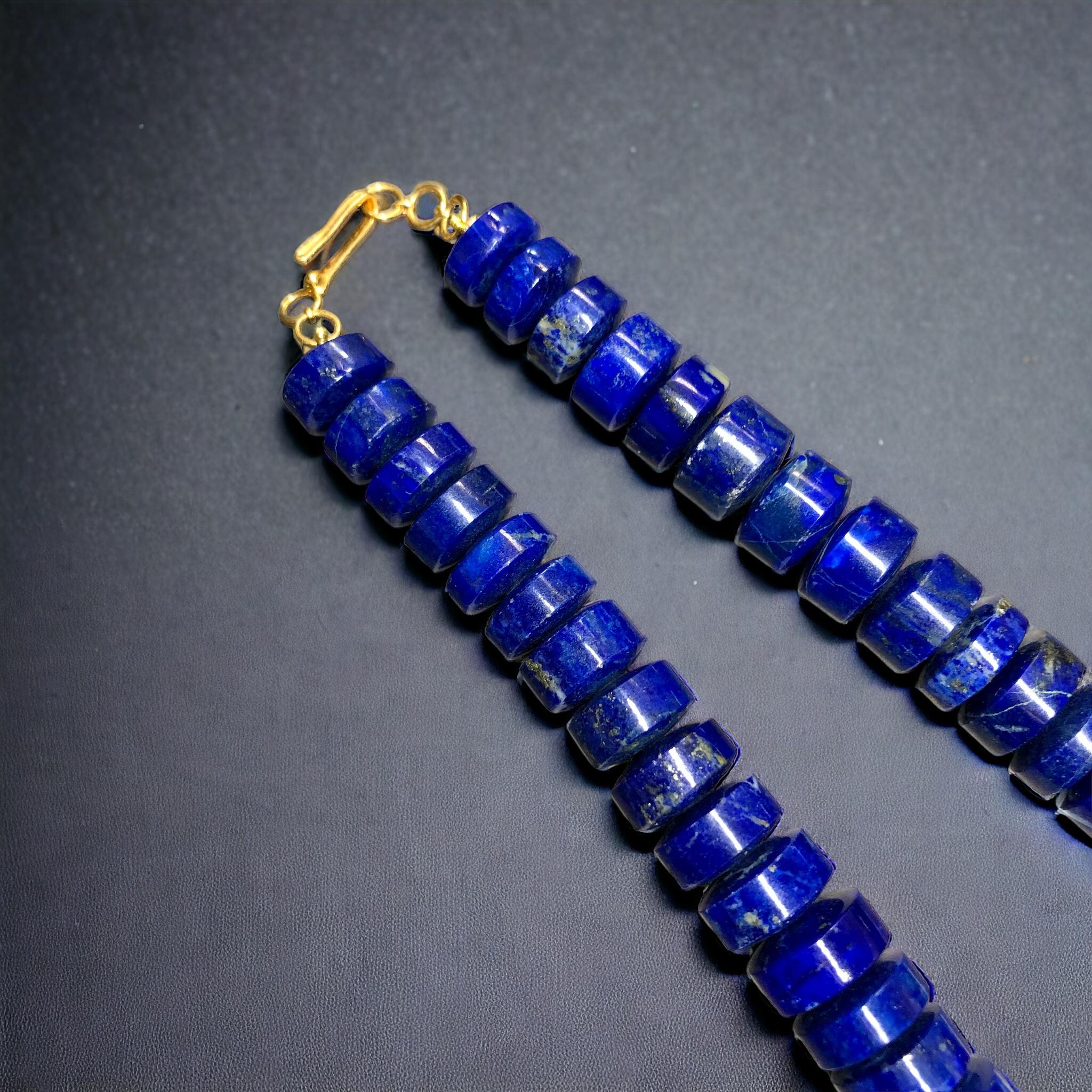 
A beautiful strand of deep blue natural cylindrical carved lapis lazuli complete with 18 karat yellow gold hook clasp.


Dimensions/Weight:

Necklace measures 15.75” and weighs 103g. Cylinders range 10.88mm to 14.40mm in diameter.


Condition:

One