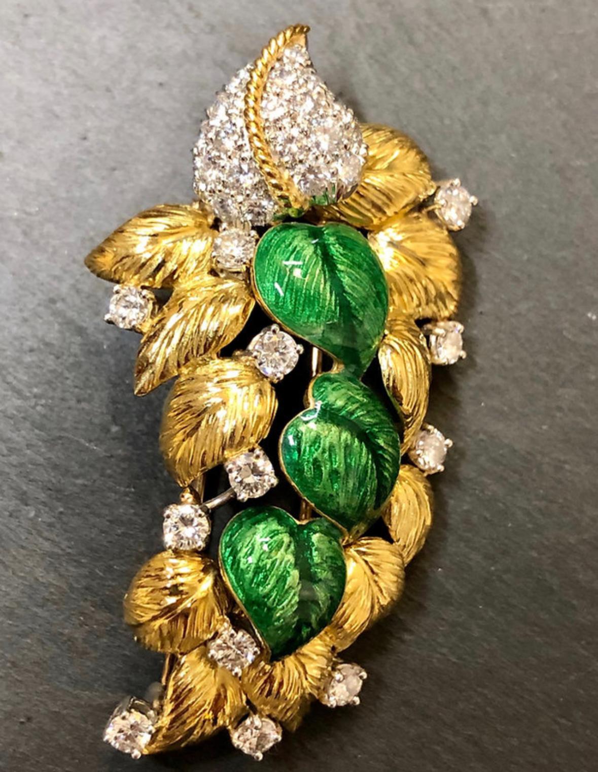 Brooch circa 1960’s done in 18K yellow gold and platinum set with approximately 2.50cttw in F-G color Vs1-Si2 clarity larger prong set and pave diamonds finished in beautiful green enamel.

Dimensions/Weight
2.10” long by 1.10” at its widest point.