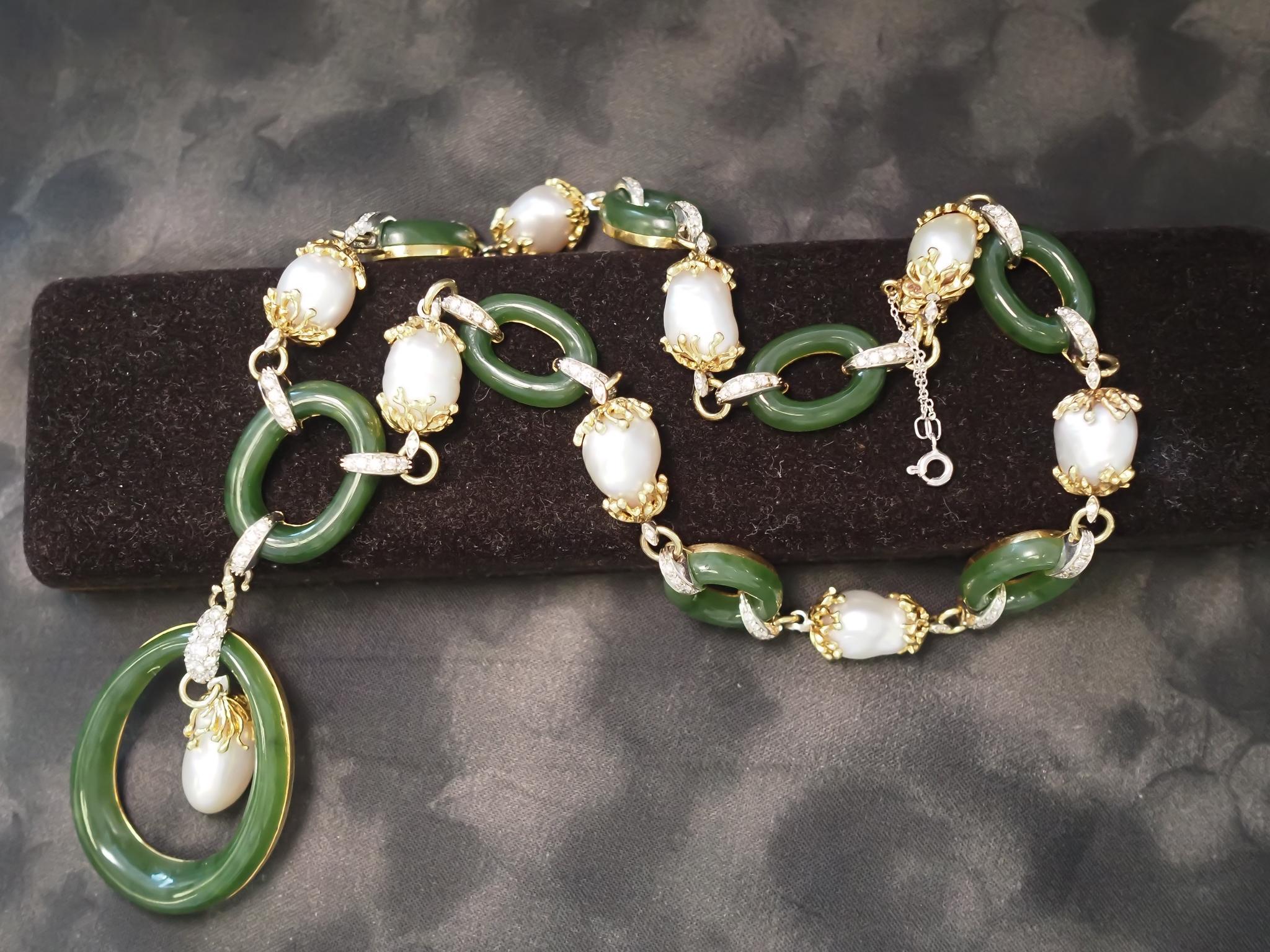 Year: 1980s
Item Details:
Metal Type: 18K Yellow Gold [Hallmarked, and Tested]
Weight: 131.0g
Diamond Details:
Weight: 2.50ct
Cut: Round Brilliant
Color: G
Clarity: VS
Each jade oval is 1 inch long and the bottom jade ring is 2 inches long. Pearls