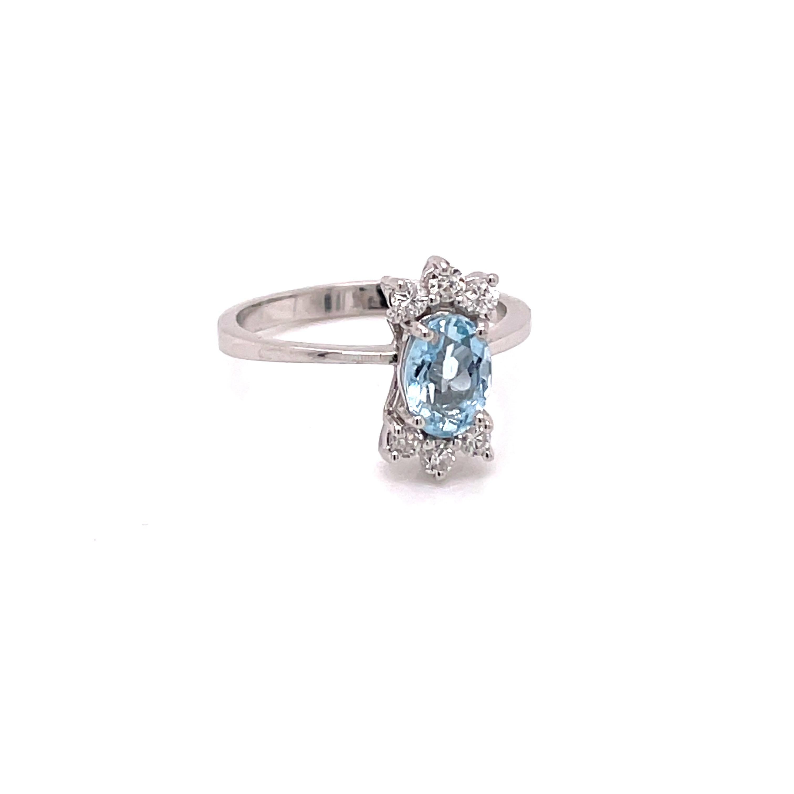 Vintage 1960's .75ct Oval Cut Aquamarine ring with Diamonds - The aquamarine weighs approximately .75ct and measures 7.3 x 5mm.  It is accented with 6 round brilliant diamonds weighing approximately .24ct G -H color SI clarity.  The setting is 14k