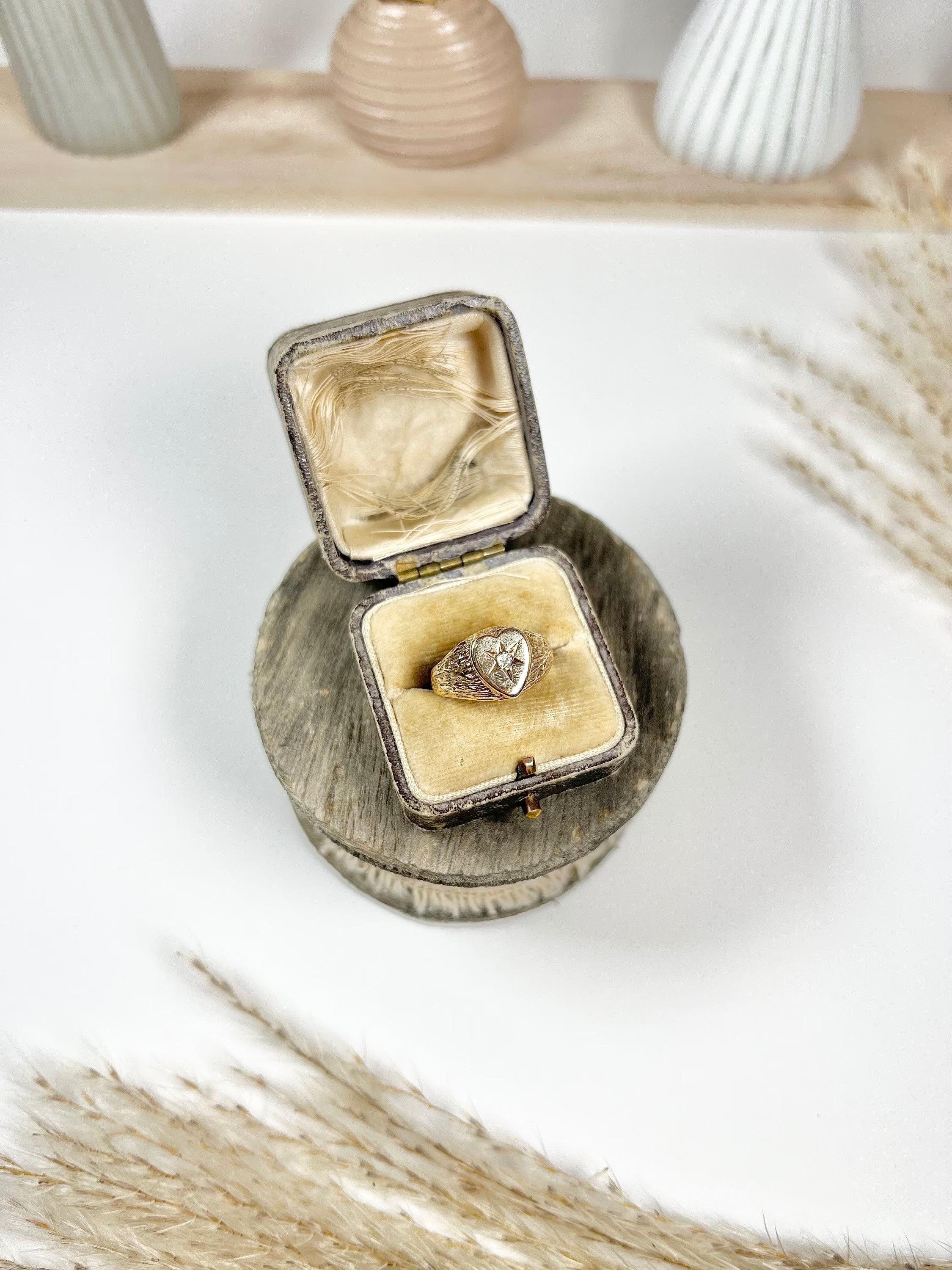 Vintage Signet Ring 

9ct Gold 

Hallmarked Birmingham- No Date Letter

Makers Mark A & P

Circa 1960’s

Lovely, vintage signet ring. Heart shaped with a single, star-set diamond. Mounted in lovely yellow gold with bark effect detailing to the