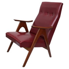 Vintage 1960s armchair in burgundy faux leather and teak wood Vintage 1960s armchair in burgundy faux leather and teak wood