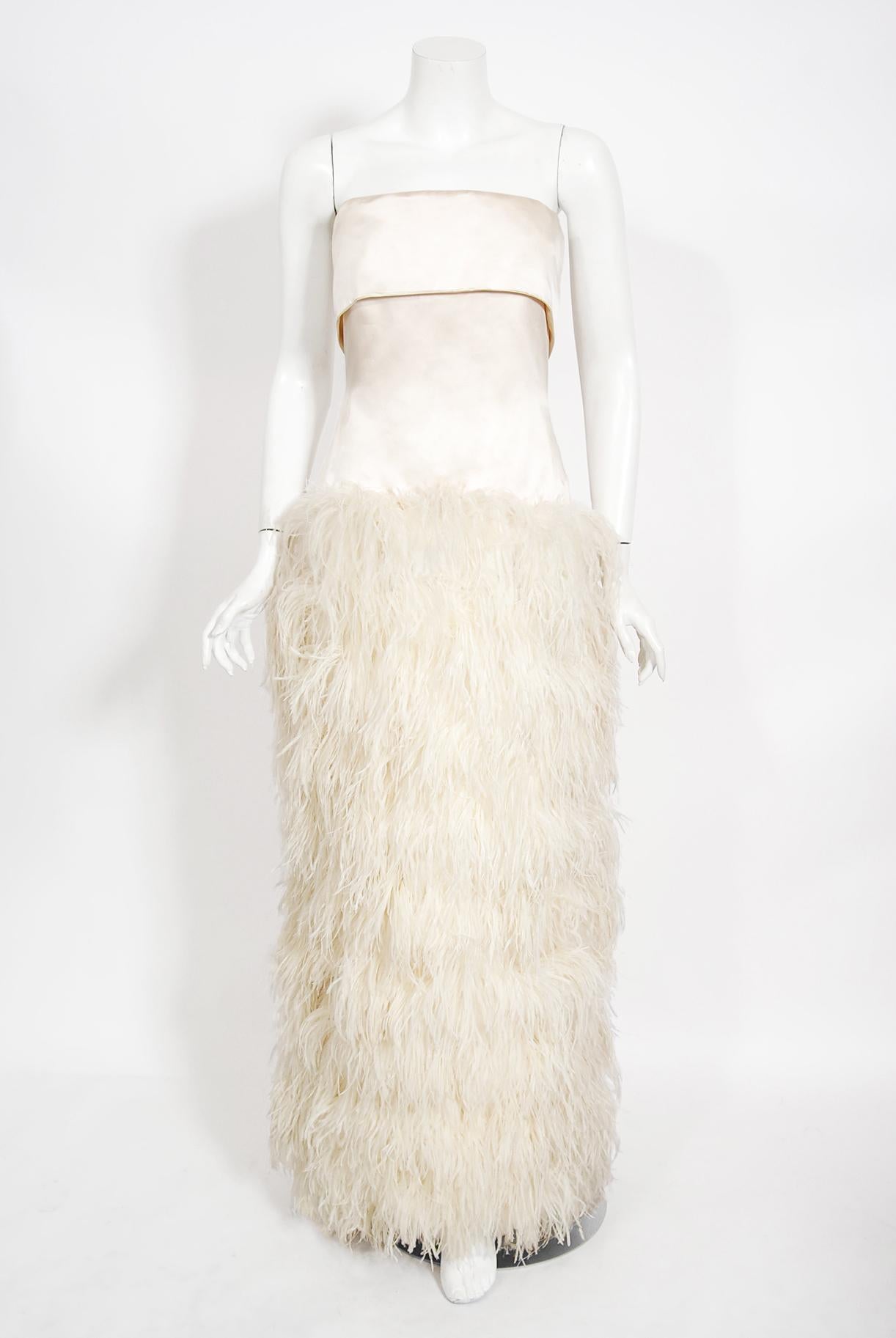 An absolutely gorgeous Arnold Scaasi custom couture ivory silk-satin feathered gown dating back to the mid 1960's. Scaasi started his career designing for Charles James in the 1950's. He opened his own ready-to-wear business with $2,000 in savings