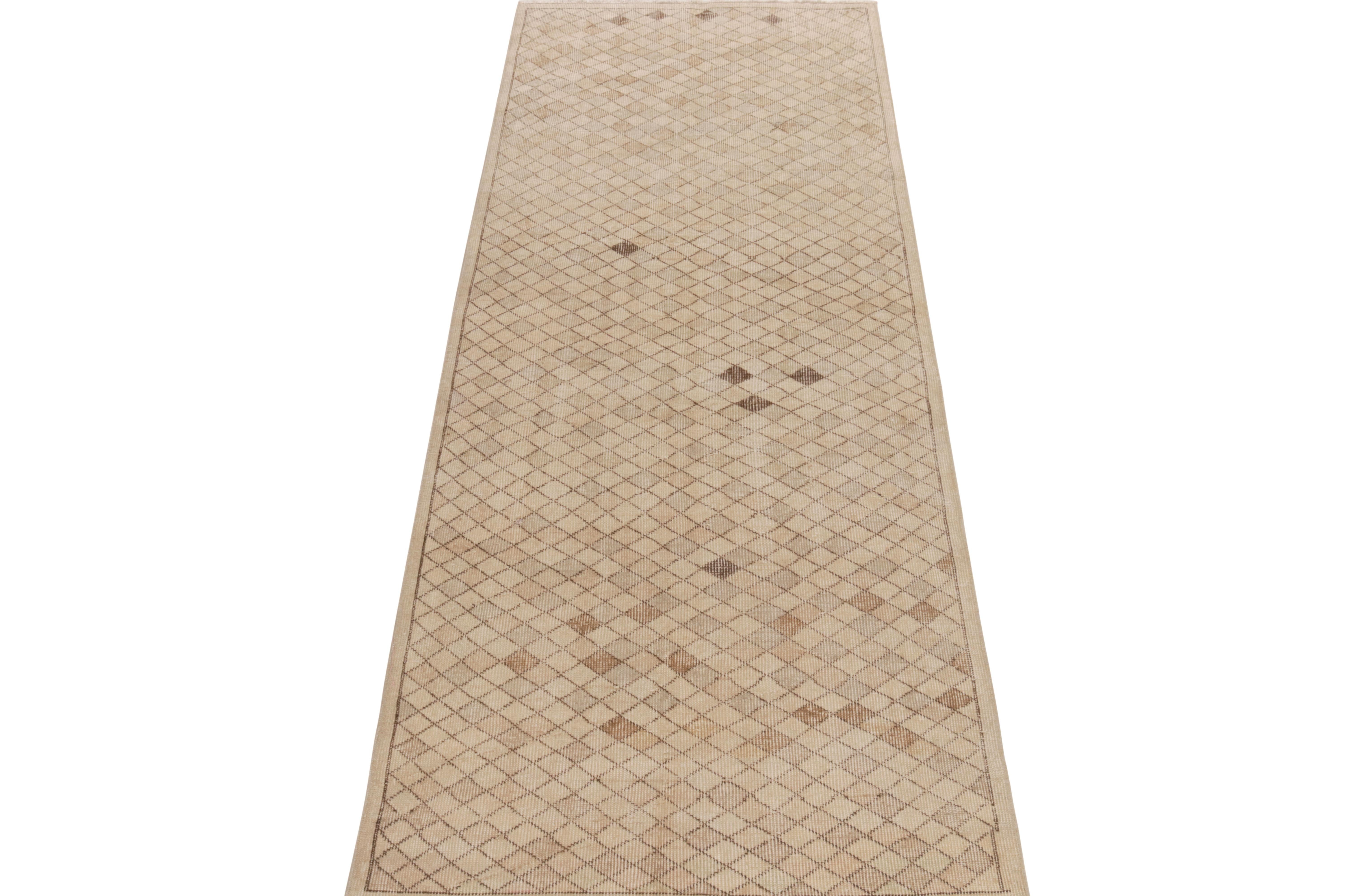 Belonging to Rug & Kilim’s mid century Pasha collection, a 1960s runner celebrating the works of a venerated designer from Turkey. 

Hand-knotted in wool with a low-sheared, distressed textural approach, this 3x9 vintage rug features a geometric