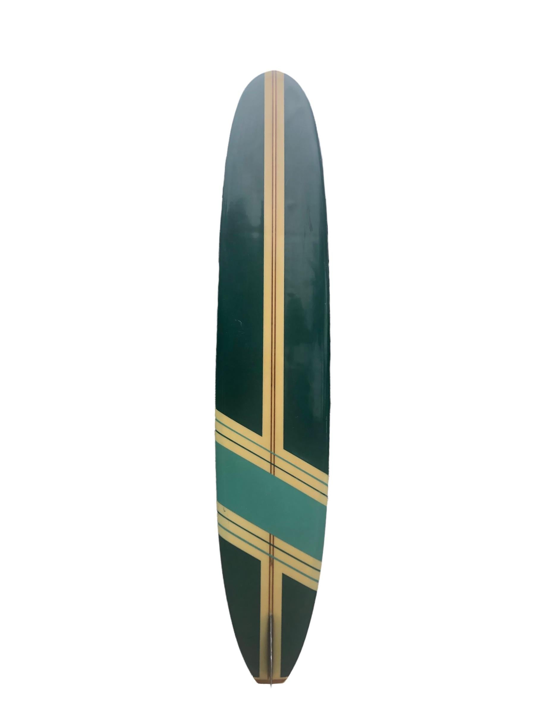 Mid-1960s Bing Surfboards competition longboard. This vintage longboard features a competition band indicating it was used in surfing contests during the 1960s. Beautiful dark green panels with ornate pin line design. Redwood and balsawood T-band