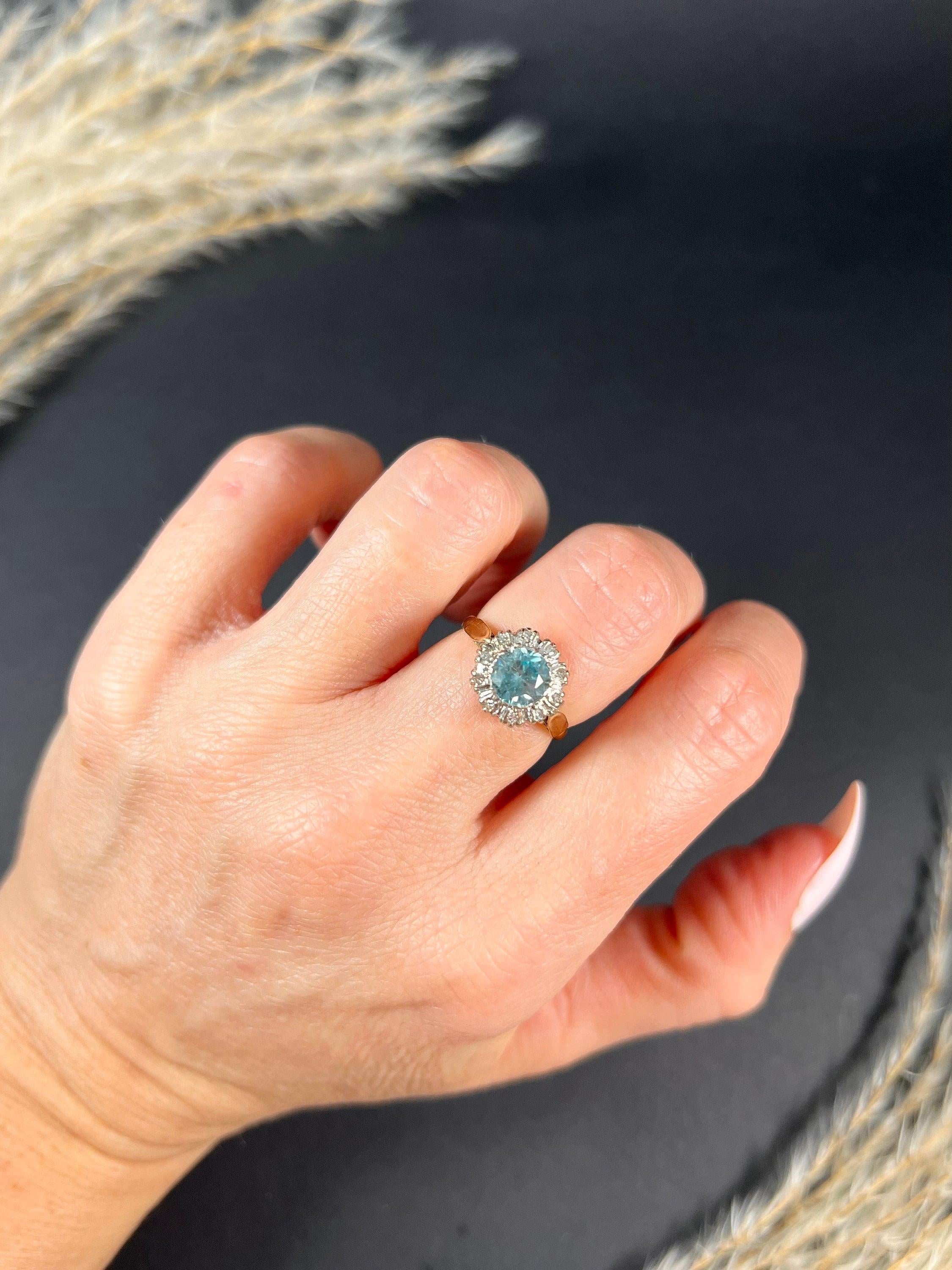 Antique Zircon & Diamond Ring 

18ct Gold Stamped

Hallmarked Birmingham 1968

Makers Mark T & B

This stunning vintage cluster ring from the 1960s features a beautiful zircon centre and a fabulous cluster of natural diamonds. It is mounted on an