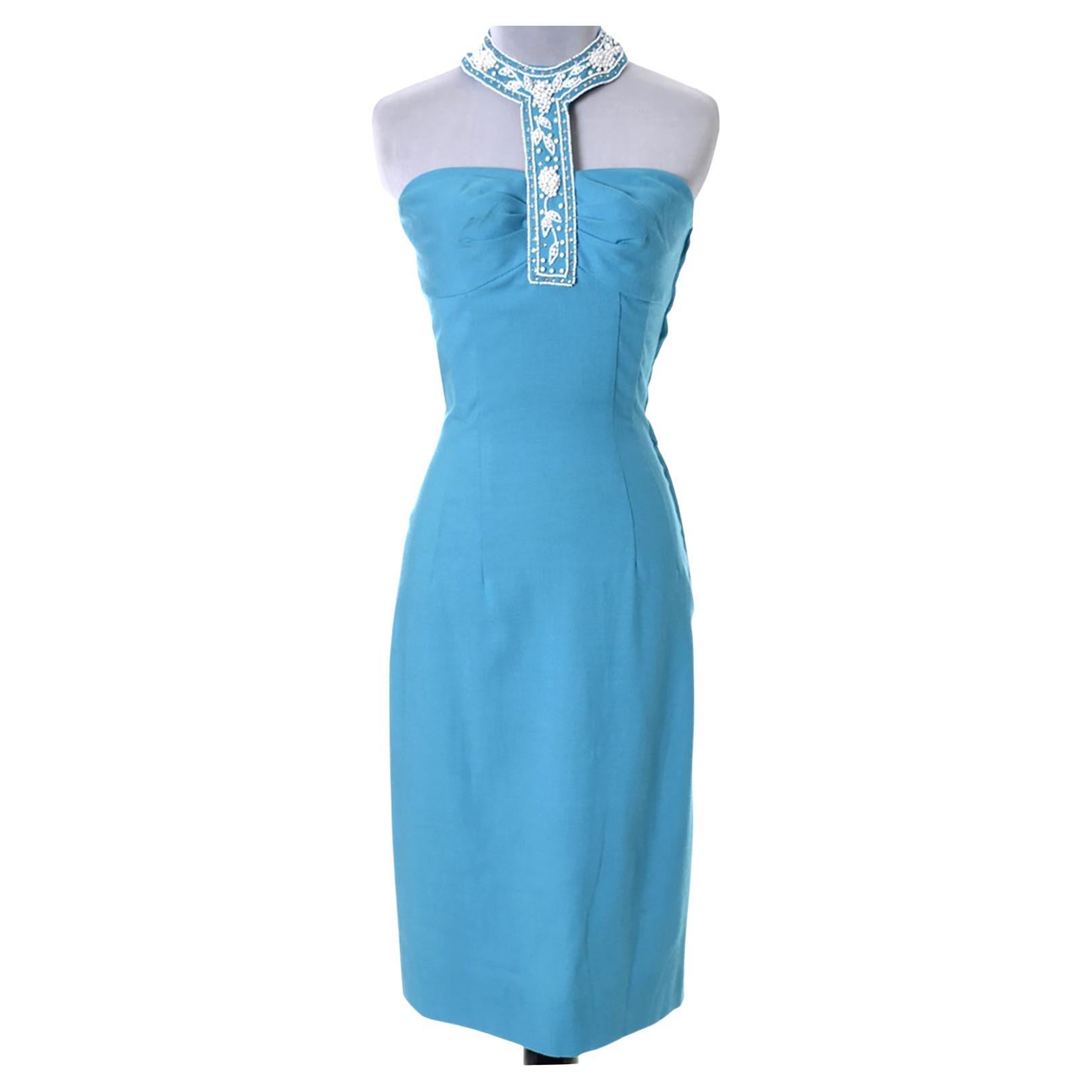 This is an incredible vintage Caribbean blue linen dress with a stunning beaded halter style collar with rhinestones.  This hourglass wiggle dress has 