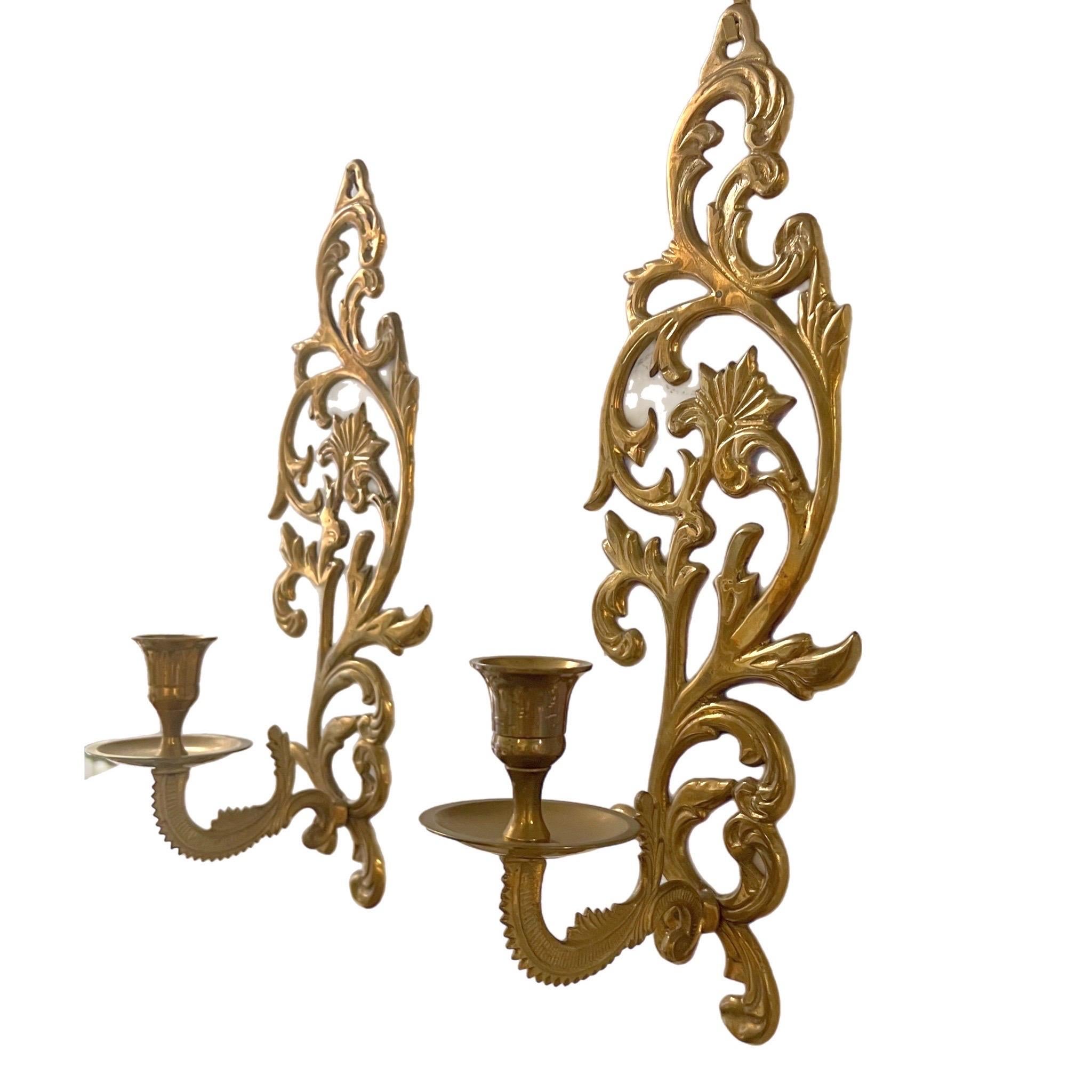 A pair of show-stopping scroll motif brass candlestick sconces. Awesome pop of glam for nearly any space. Great for a fireplace wall, living room, gallery wall, bathroom, or bedroom. Would also make a great addition to a library / study / office 