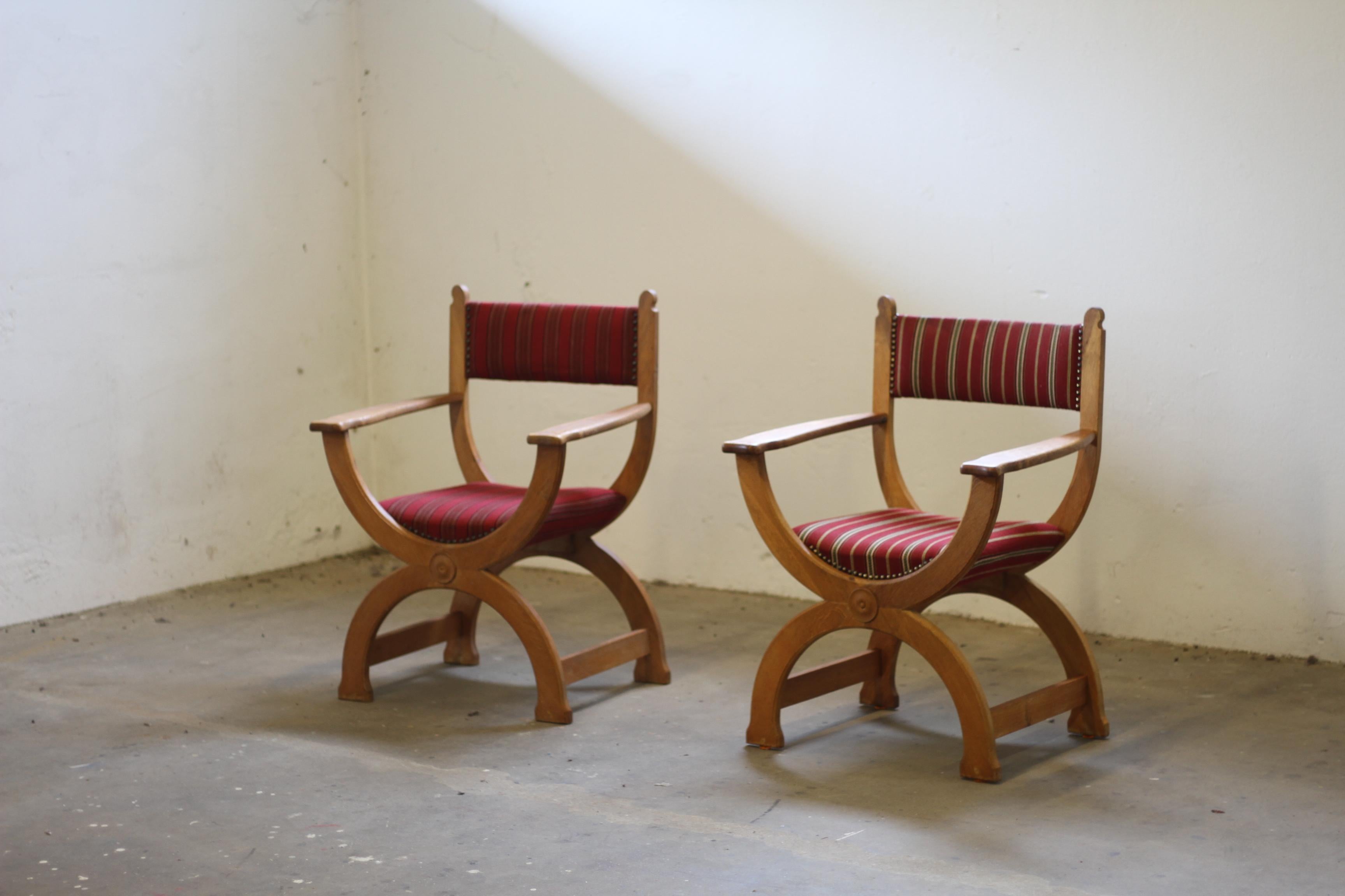 Vintage Danish design armchair in a bold, baroque brutalist design with a unique throne-like silhouette. Style of Henning Kjærnulf from the 1960s. This Kurul chair is Crafted from oak wood with a wool seat, this chair is in excellent original