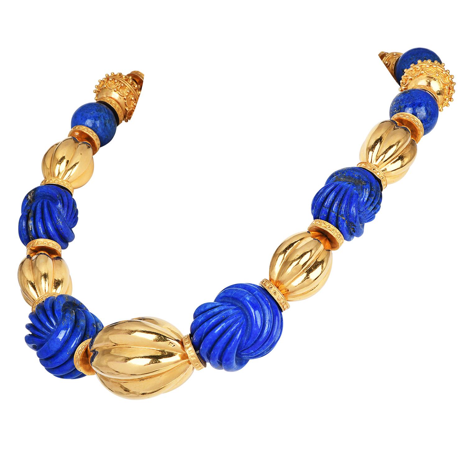 Striking and sculptural, this Chic vintage choker necklace is a bold fusion of natural beauty and fine craftsmanship. Featuring deeply carved grooved lapis lazuli segments, the necklace is set in rich 18K yellow gold, offering a stunning contrast