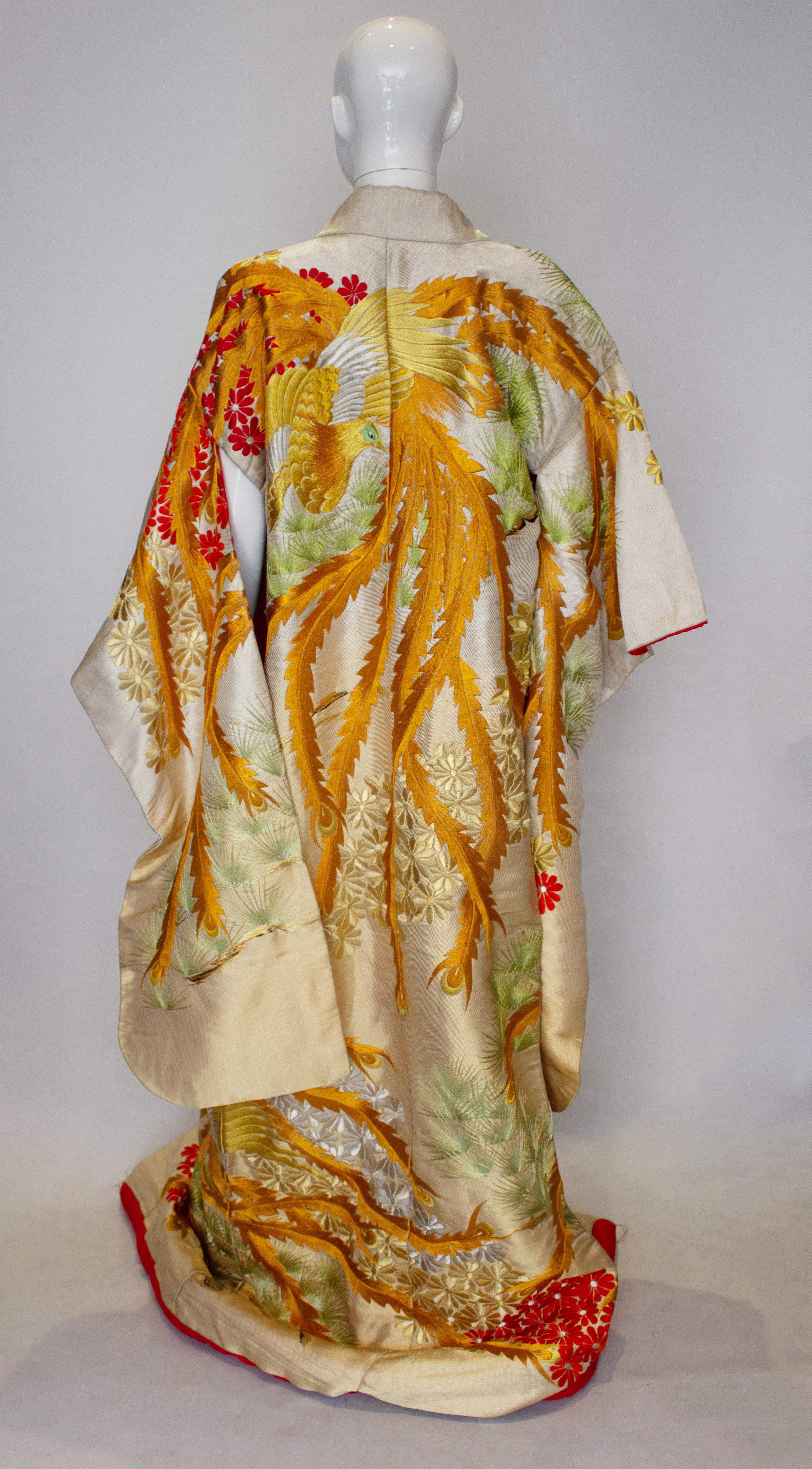A rare gold and silver lame brocade wedding kimono dating from the 1960s. It is embroidered with the imperial phoenix . This bird represents fire , the sun, justice, obedience and fidelity .It is particularly associated with Kyoto as it is supposed