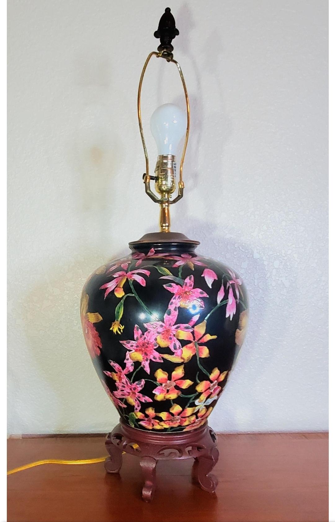 Stunning Chinese Hollywood regency ginger jar lamp.
Detailed, intricate vase includes irises and cherry blossoms.
Carved wood stand.

Looks like the ginger jar vase was made into a lamp in the 60s judging by the polarized cord.
30.5