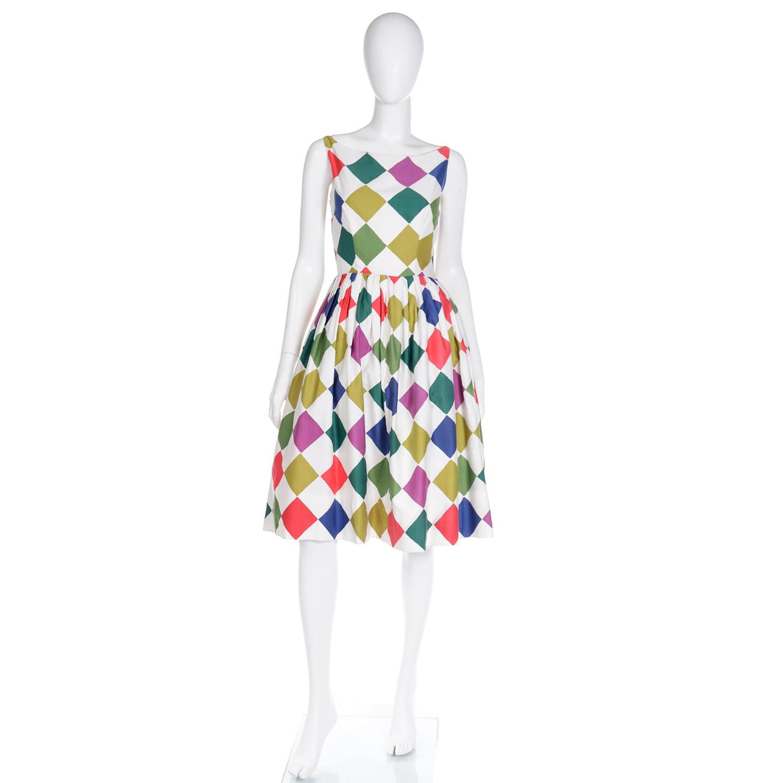 This vintage 1960's day dress is in a bold colorful diamond print. We love vintage dresses in unique prints and this one would be a really fun addition to your Summer wardrobe!

The dress is cotton and has a fitted bodice with a bateau necklne and a