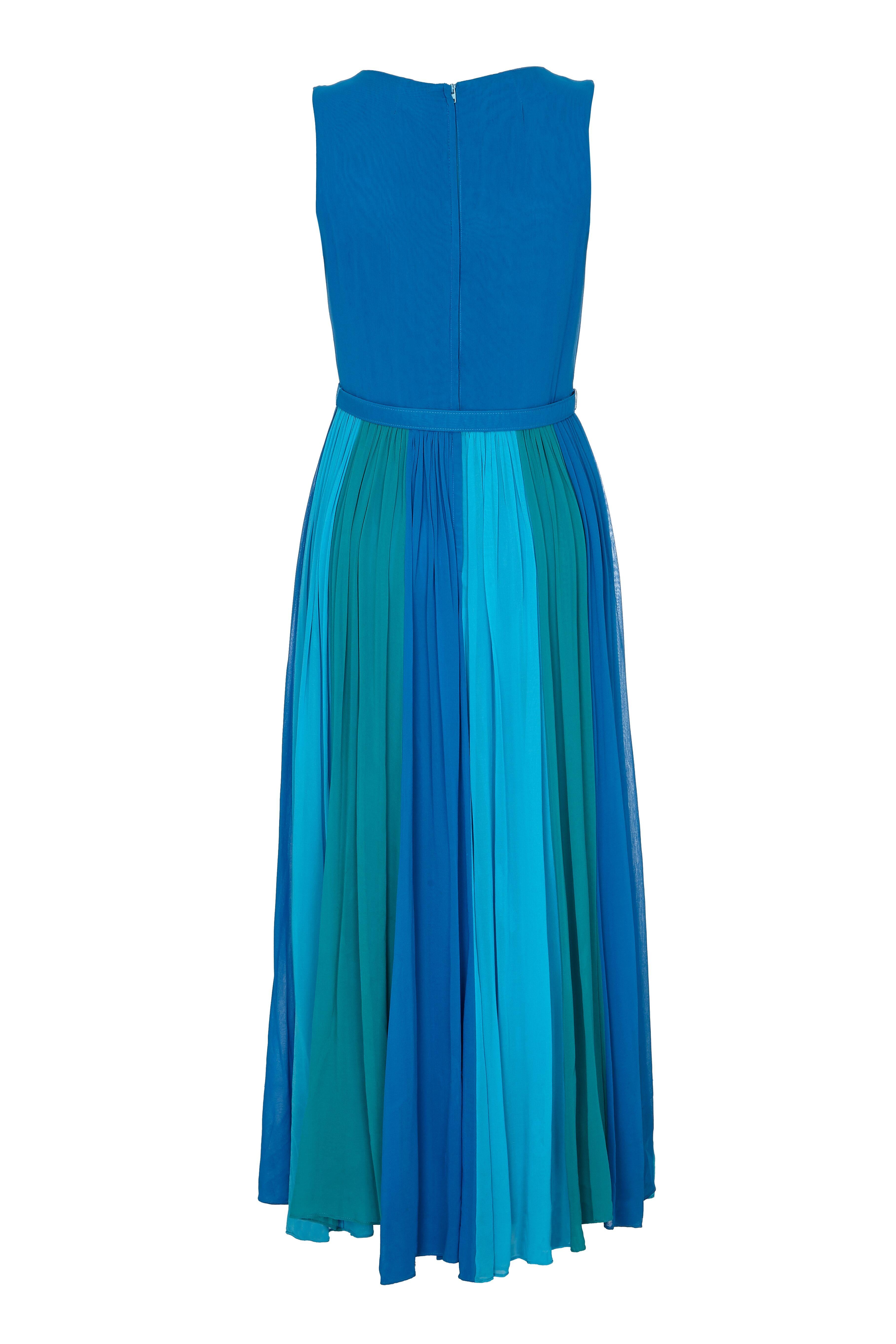 This striking 1960s silk chiffon colour block evening dress in marine blue comes with a matching fabric belt and is in beautiful vintage condition. The dress is a sleeveless shift cut with a dramatic floor sweeping skirt floating from the waist in