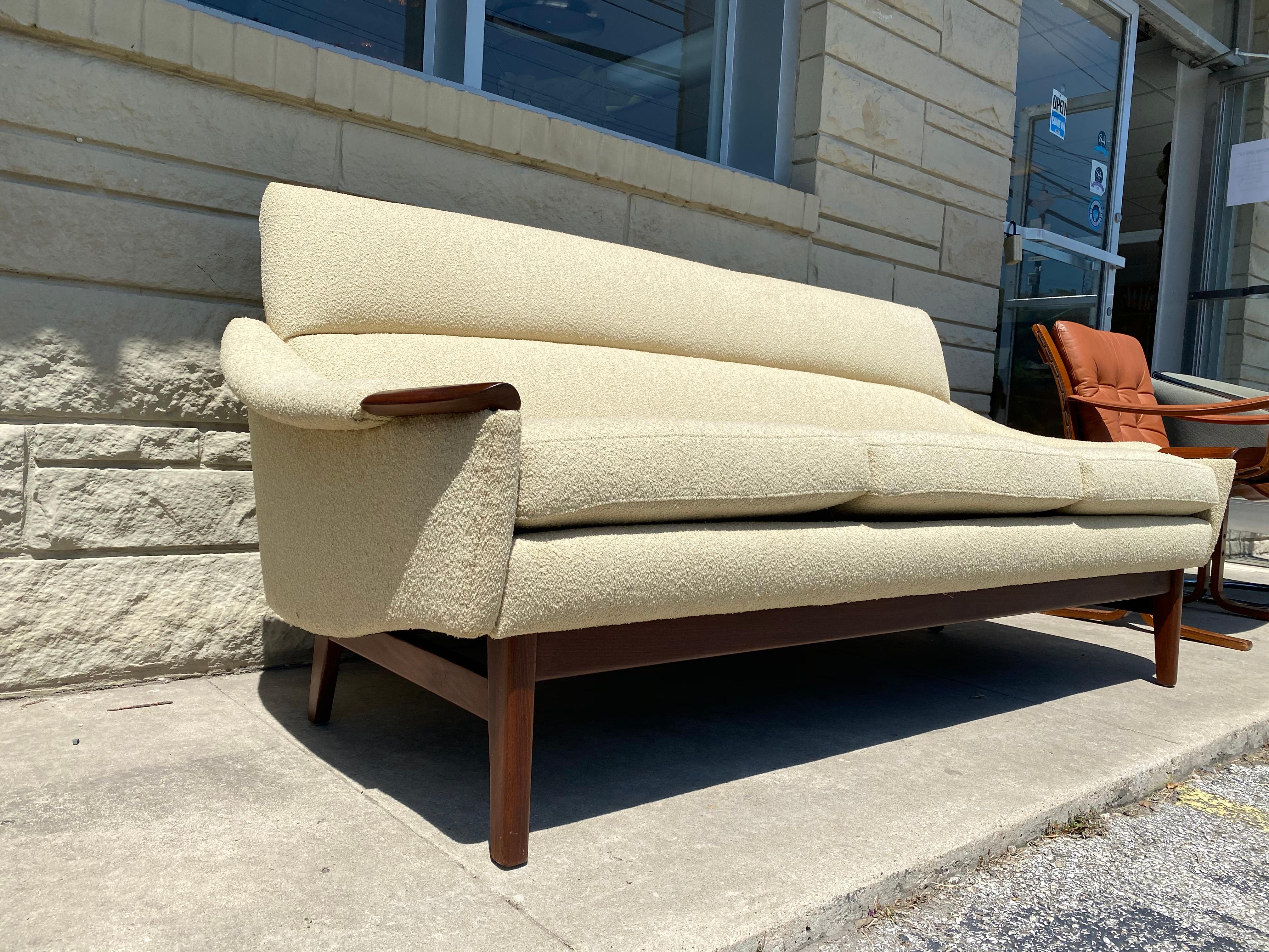 This wonderfully unique sofa was created by R. Huber & Co., and is in overall good condition. Walnut wood details. Cream colored nubby bouclé upholstery. Wear consistent to age and use.
circa 1960s. Canada.
Dimensions:
30