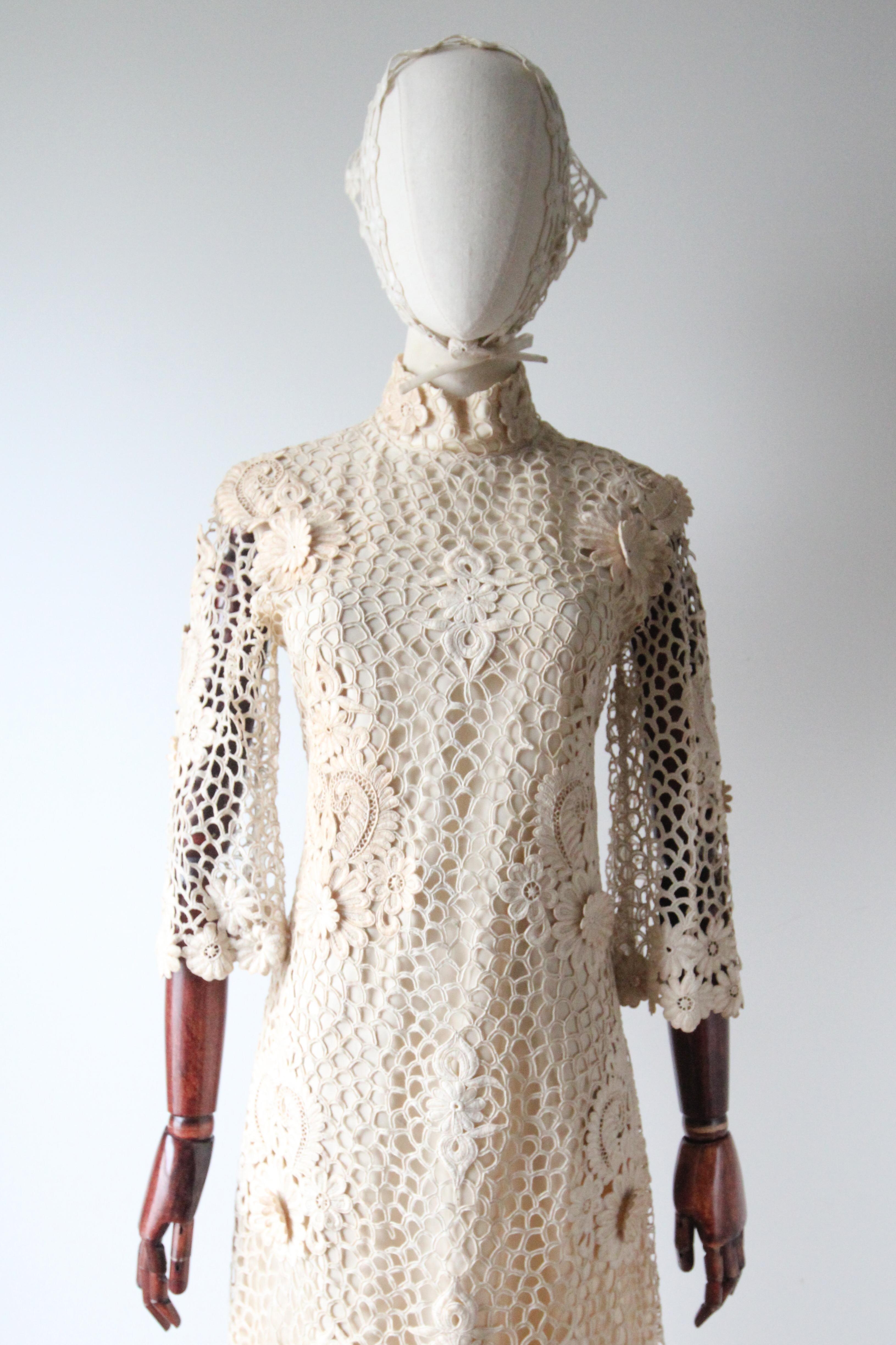 A classic silhouette rendered on a cream nylon base, which is in turn fully overlayed with cream embroidered lace, accented by floral lace appliqués above floral paisley lace designs, this original vintage 1960s dress is just the perfect piece for