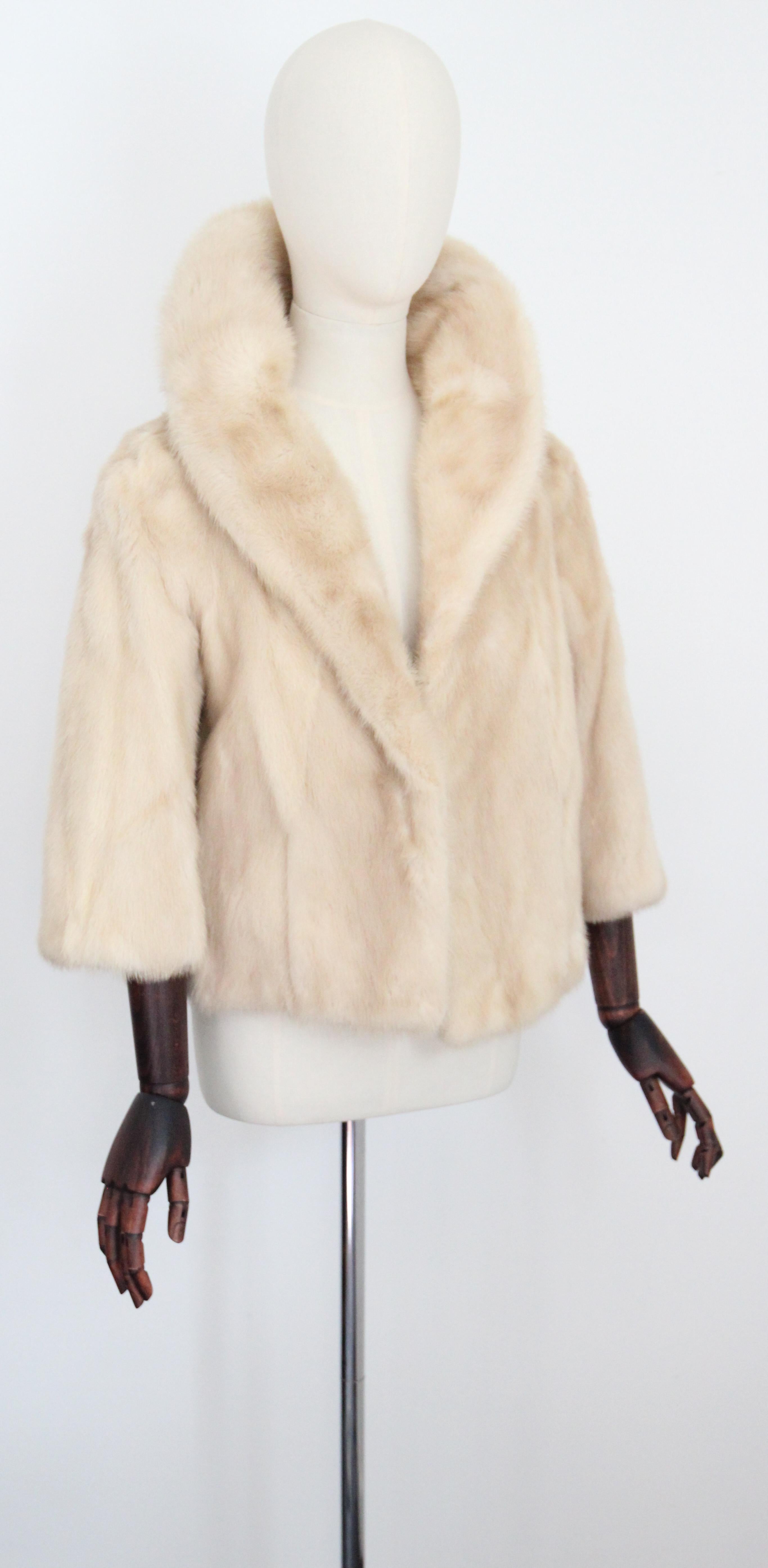 A true beauty to behold, this vintage 1960's cream mink fur jacket, by Wellan's Alexandria, rendered in an iconic design and lined in a champagne silk, is just the piece to welcome the new season with. 

The V shaped neckline is framed by a rounded