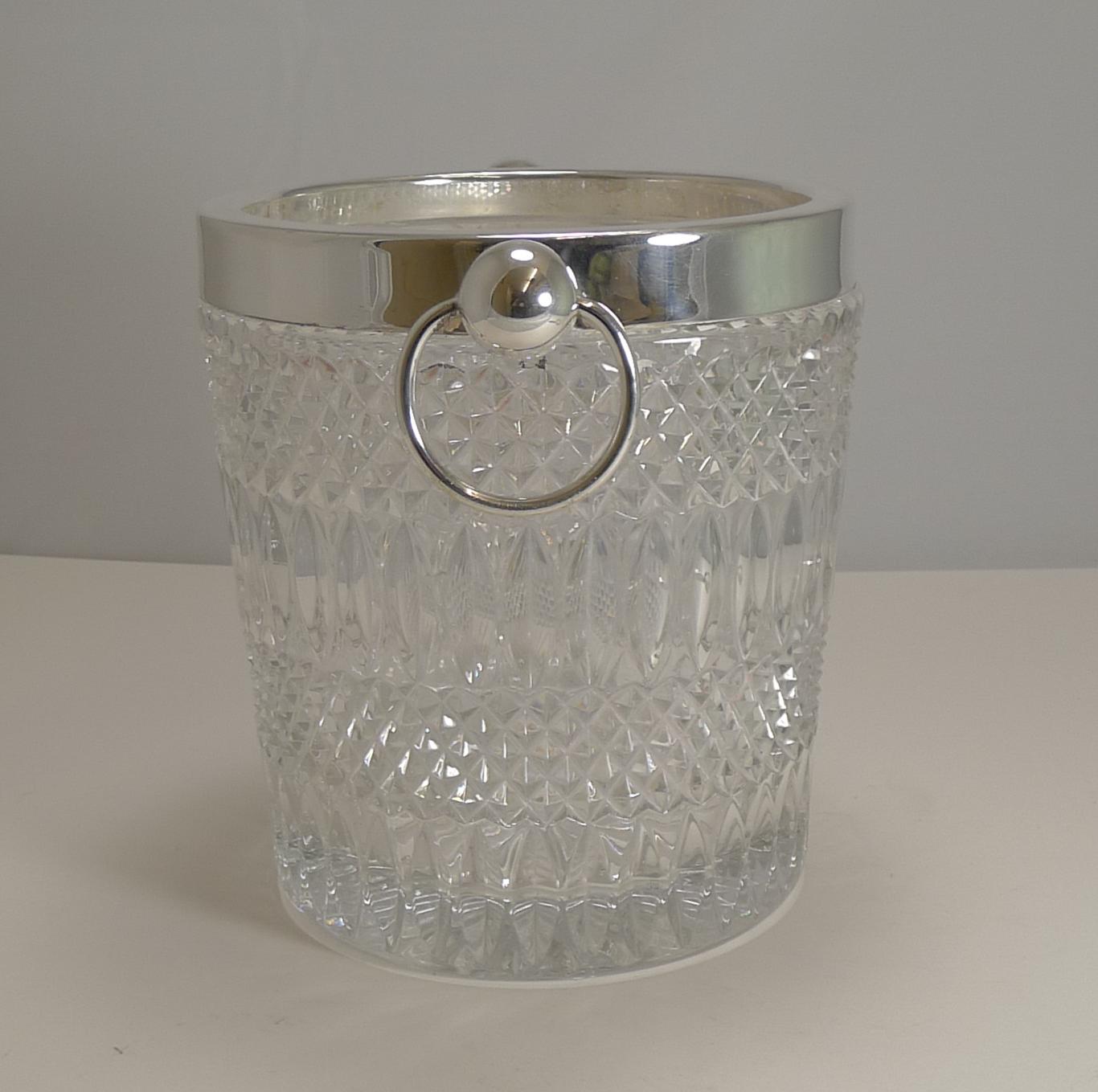 An extremely hefty piece of glass was used to create this stunning Mid-Century Modern wine cooler with silver plated fittings including a ring handle to each side.

European in origin, possibly Austrian or German dating to the 1960's in excellent
