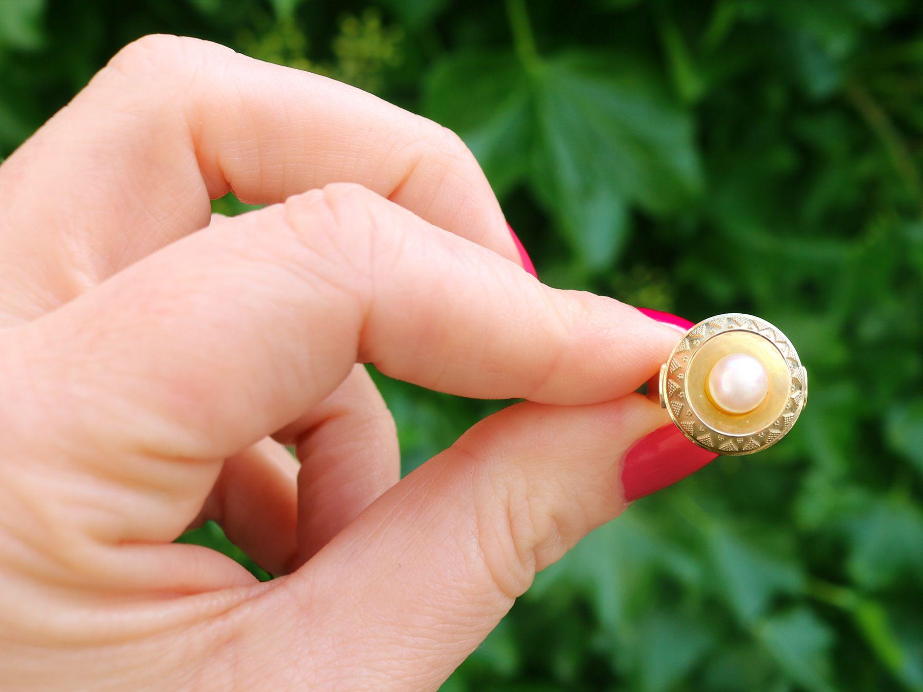 An impressive vintage 1960s cultured pearl and 14 karat yellow gold cocktail ring; part of our diverse pearl jewelry and estate jewelry collections.

This fine and impressive vintage pearl ring has been crafted in 14k yellow gold.

The rounded