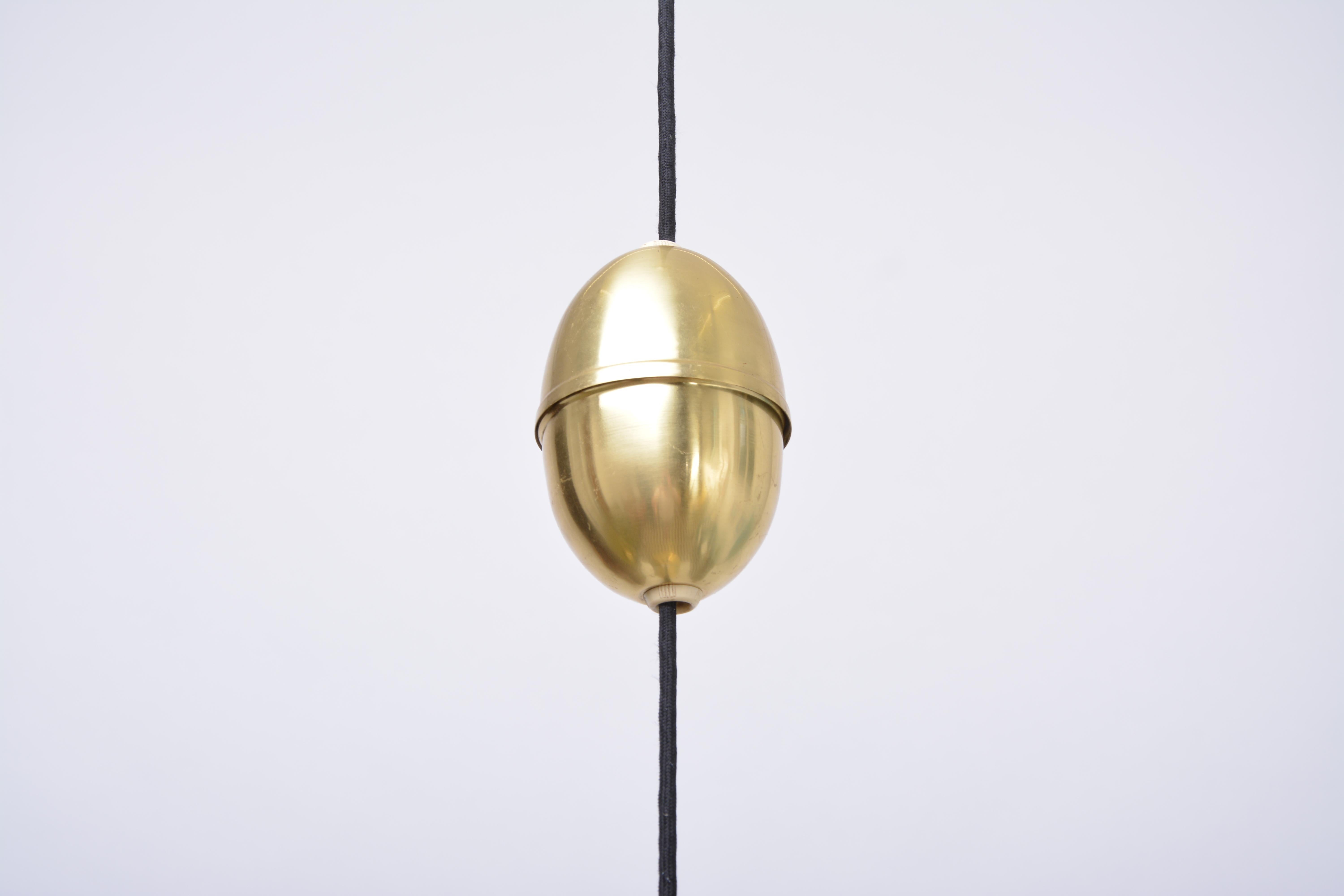 Danish Mid-Century Modern Brass pendant light by Fritz Schlegel for Lyfa

This solid brass pendant light was designed by Fritz Schlegel in the 1960s.
The model P 295 was manufactured by Lyfa in Denmark and features a brass mounting bracket with