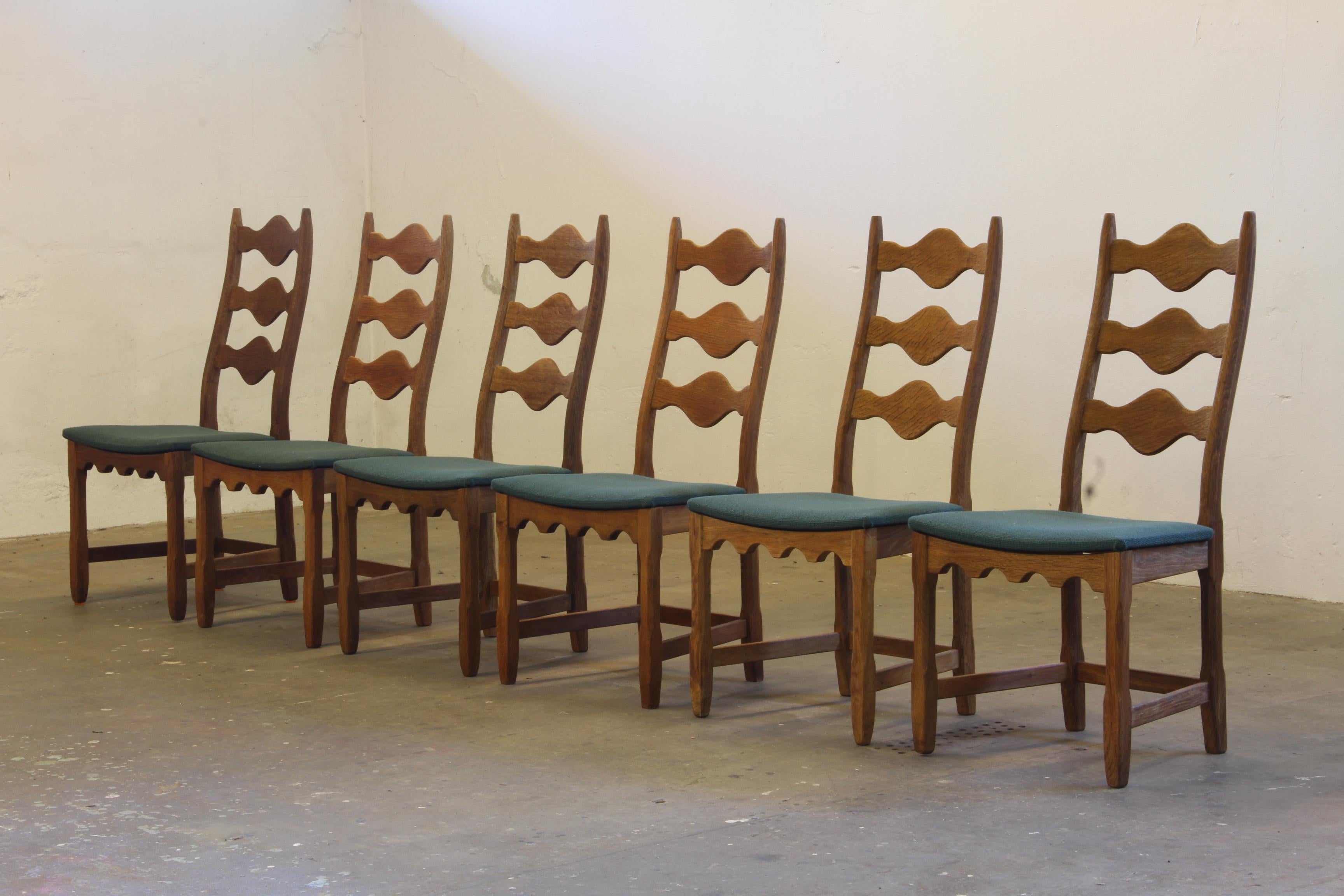 This set of six carved oak ladder-back chairs, familiar to the 