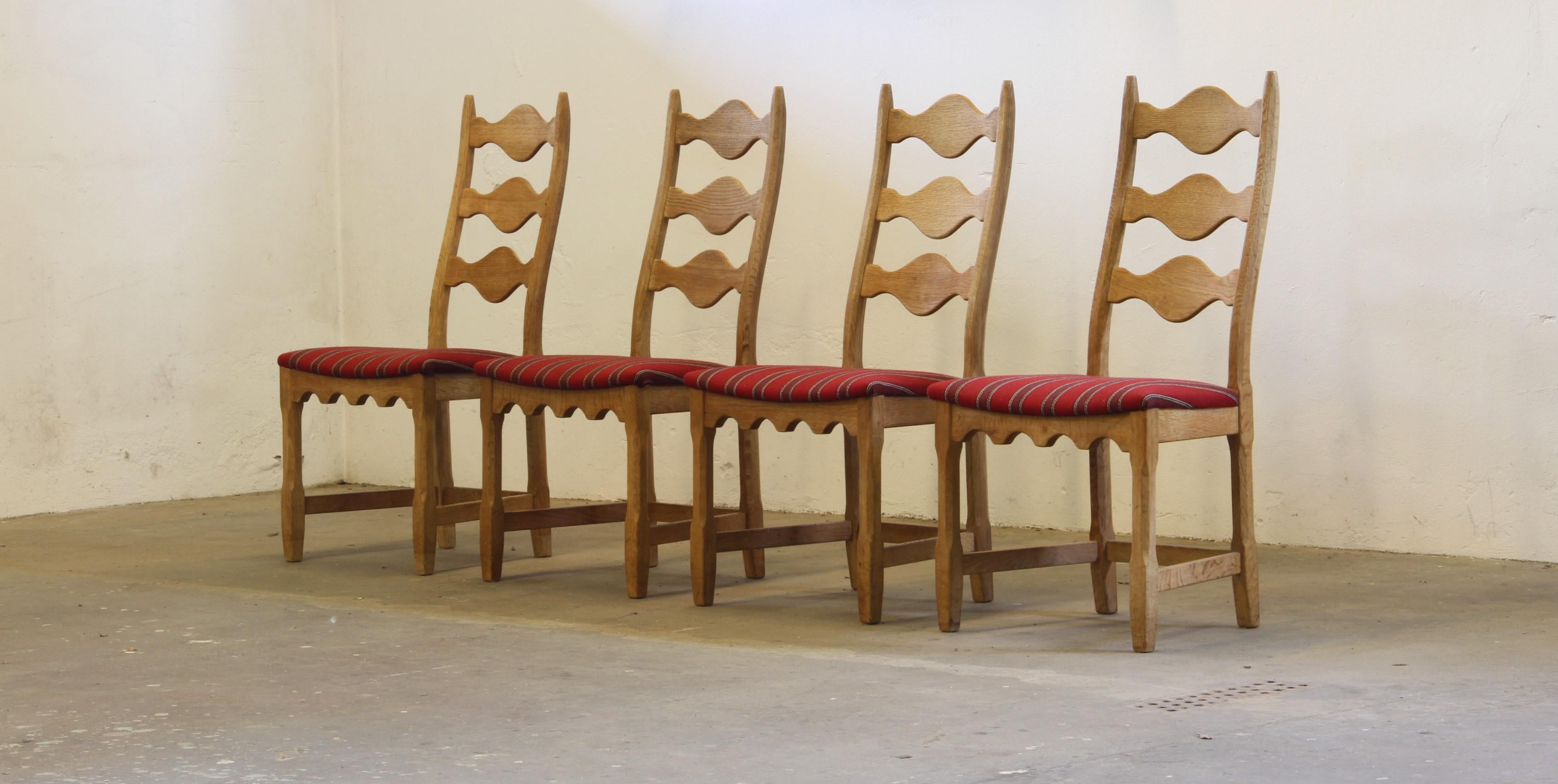 This set of four carved light oak ladder-back chairs, familiar to the 