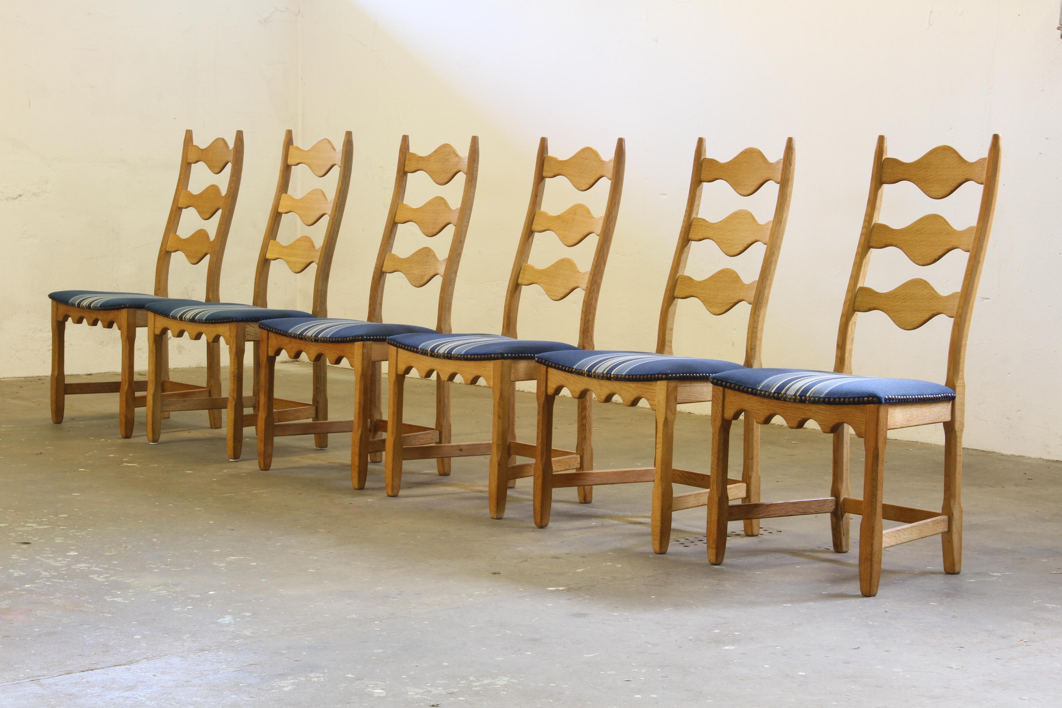 This set of six carved light oak ladder-back chairs, familiar to the 