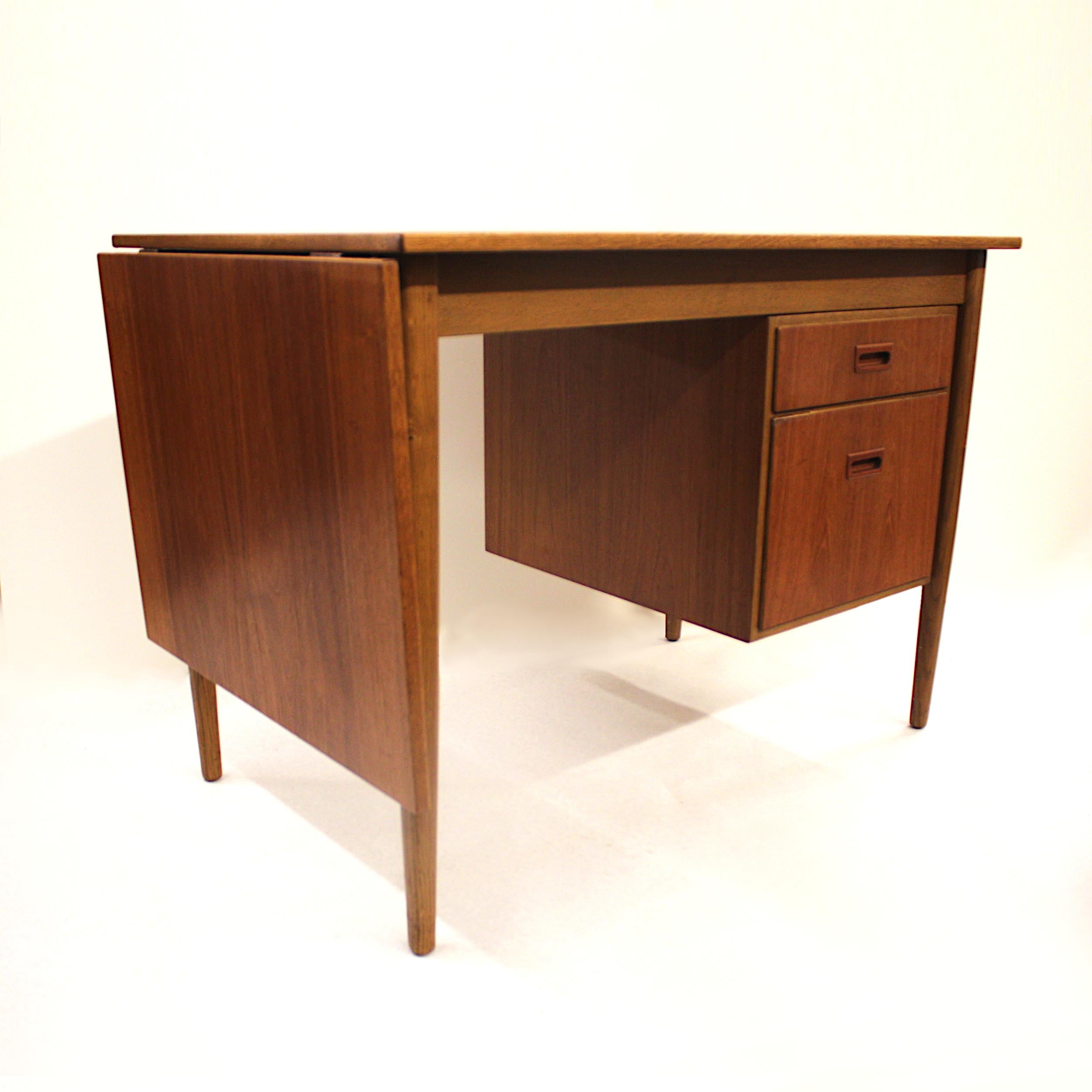 This nifty little desk was made in the 1960s by The Swedish furniture manufacturer Treman. Desk has a number of novel features including a sliding, drop-leaf top that extends the work surface from 41