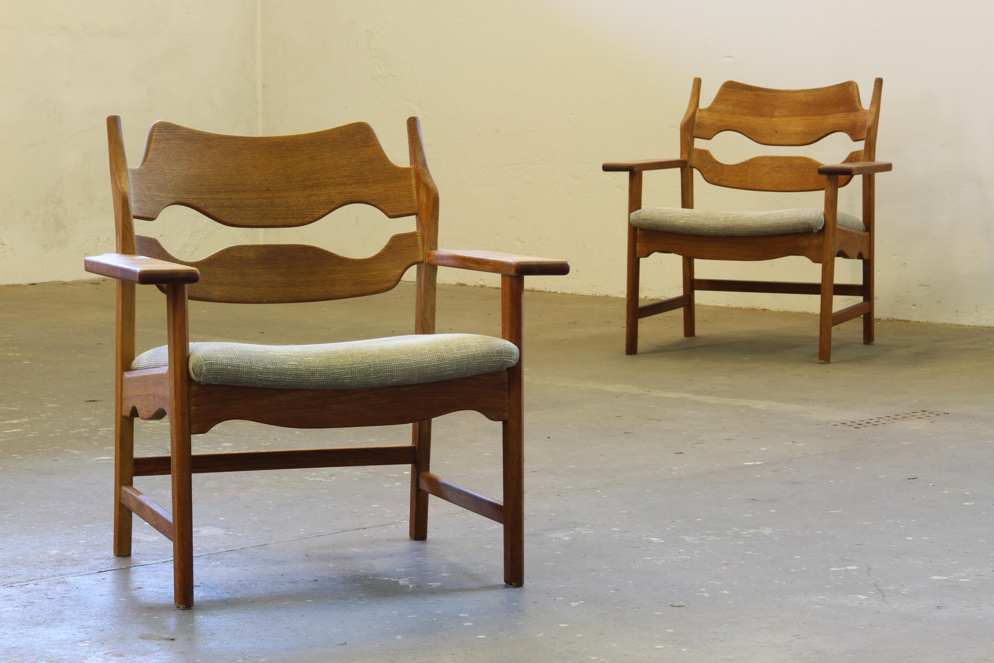Mid-century Danish lounge chair, razorblade model crafted by Henning Henry Kjærnulf, exemplifies the timeless appeal of Scandinavian design. Made from solid oak, this piece was created by EG Kvalitet and both chairs has a sticker underneath the