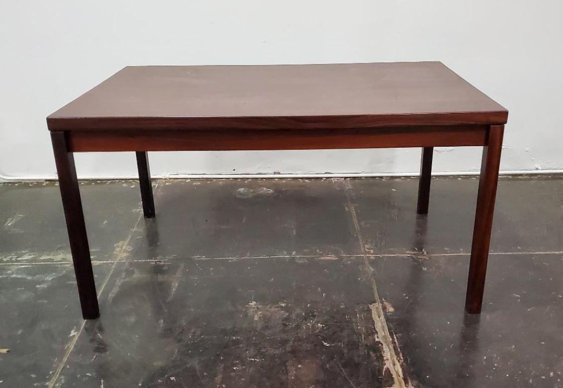 Vintage 1960s Danish Rosewood Extendable Dining Table Made In Denmark. 
Beautiful Rosewood Extendable Danish Modern Dining Table With Two Extendable Leaves Tucked Under Table Top. Leaves Easily Slide Out When Applied. Table Top Sits Firmly On Top.