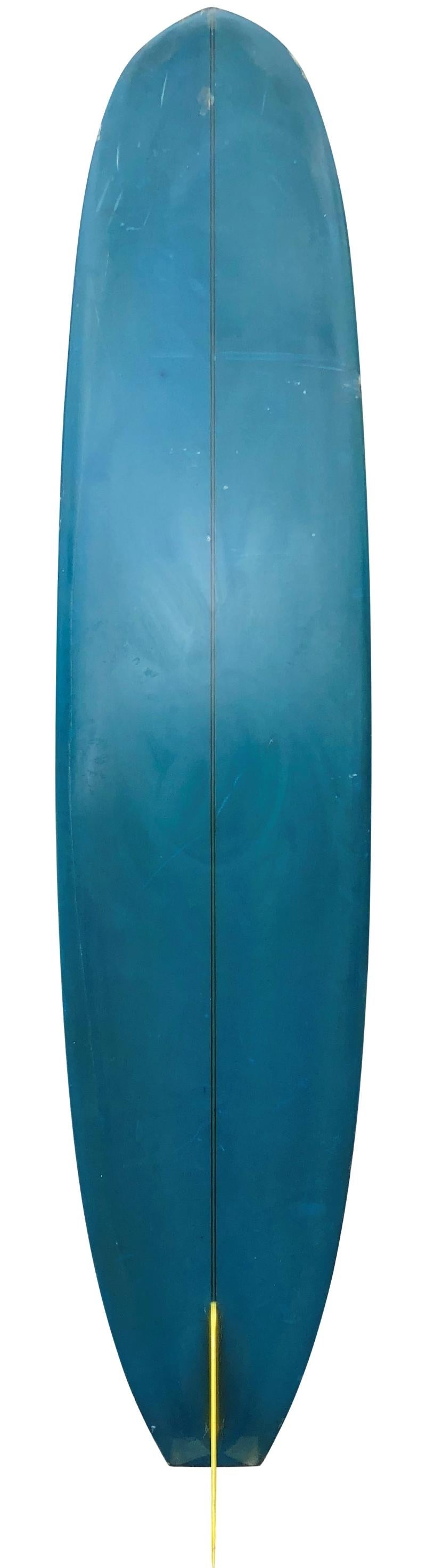 1967 Bing David Nuuhiwa light-weight model longboard shaped in 1967, serial #8375. Features a beautiful deep blue tinted bottom/wrapped rails with pinline, T band stringer, and glass-on single fin. A particularly short example of a Nuuhiwa