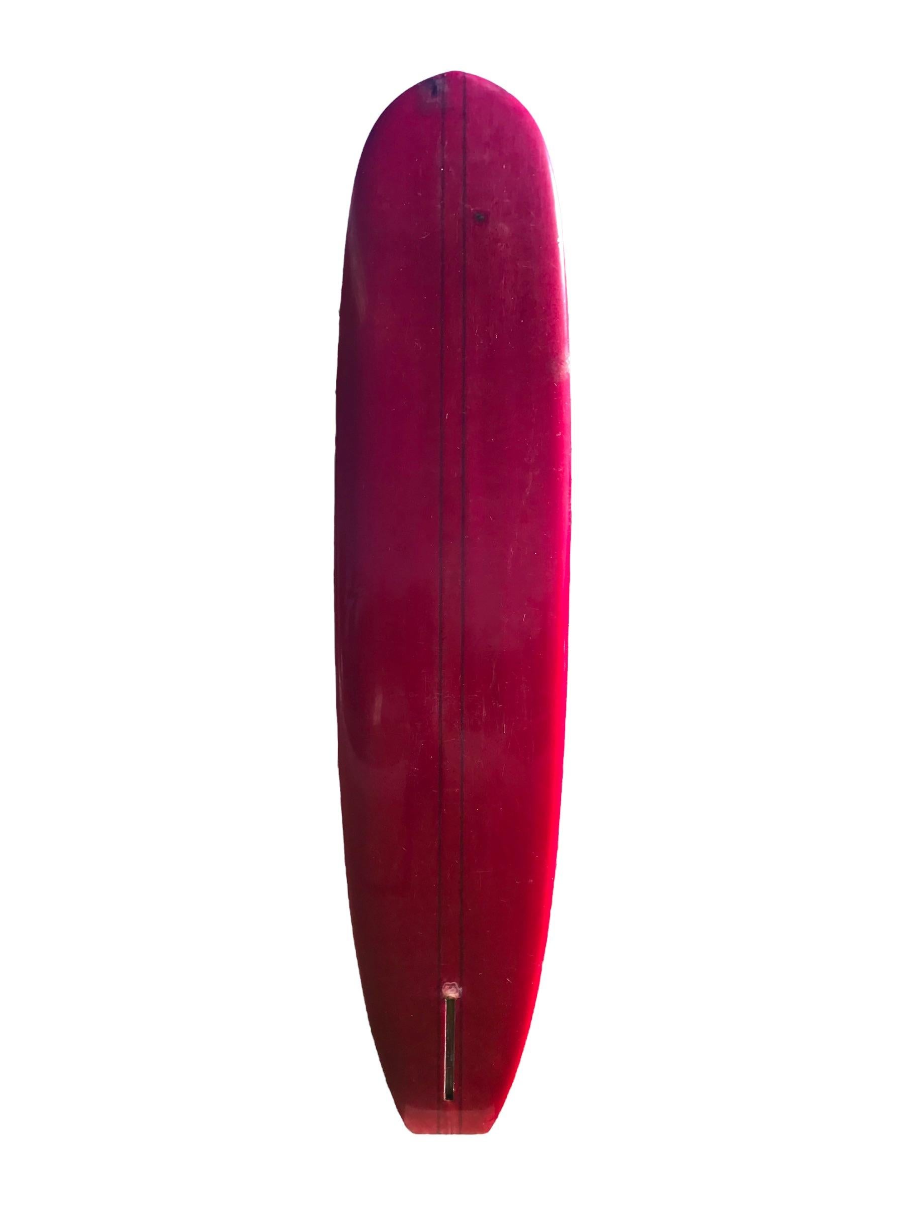 1967 Dewey Weber Performer model longboard. Features a double stringer shape design with beautiful burgundy and orange tints. Black pinstriping and hatchet fin complete with original “Wonderbolt” fin screw. A remarkable all original example of one