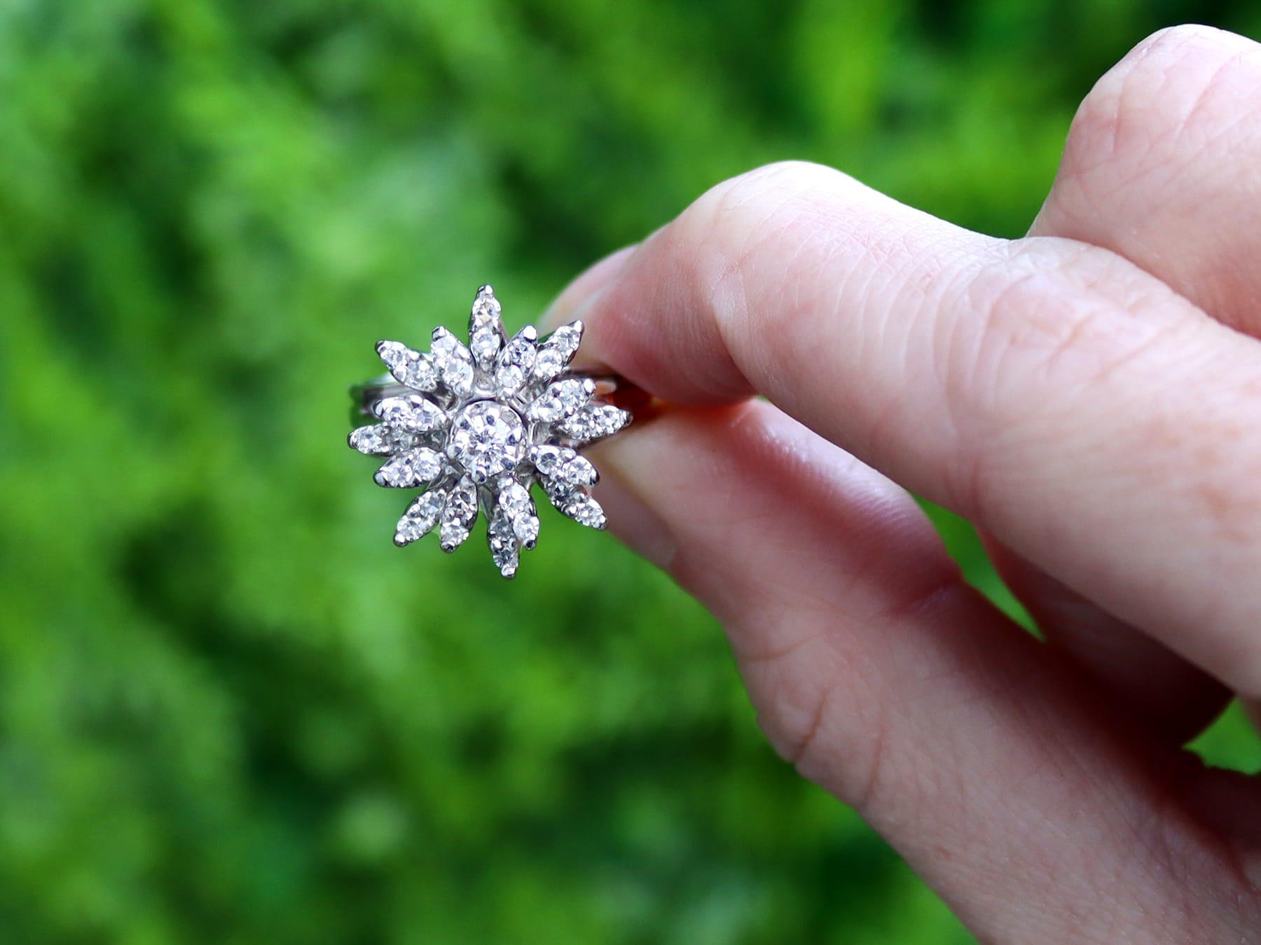 A fine and impressive vintage 0.95 carat diamond and 14 karat white gold cluster ring; part of our vintage jewelry and estate jewelry collections.

This impressive vintage diamond cluster/dress ring has been crafted in 14k white gold.

The