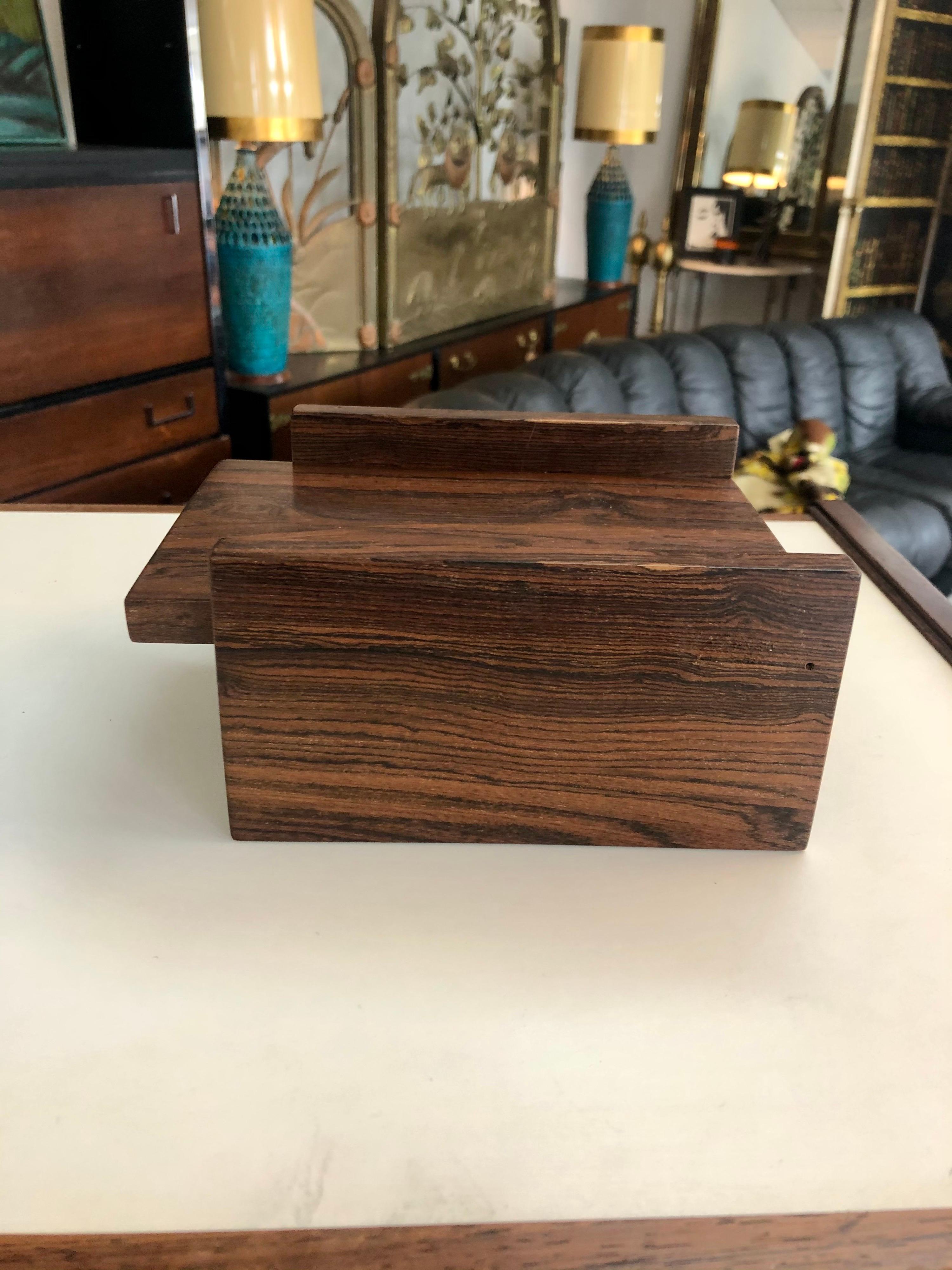 Designed by Don S. Shoemaker, this beautiful cocobolo cigarette box is in overall good condition. Minor scratch on top of box and several minor scratches on the bottom of the box. (See photos). Senal SA labeled on bottom of the box,
Mexico,