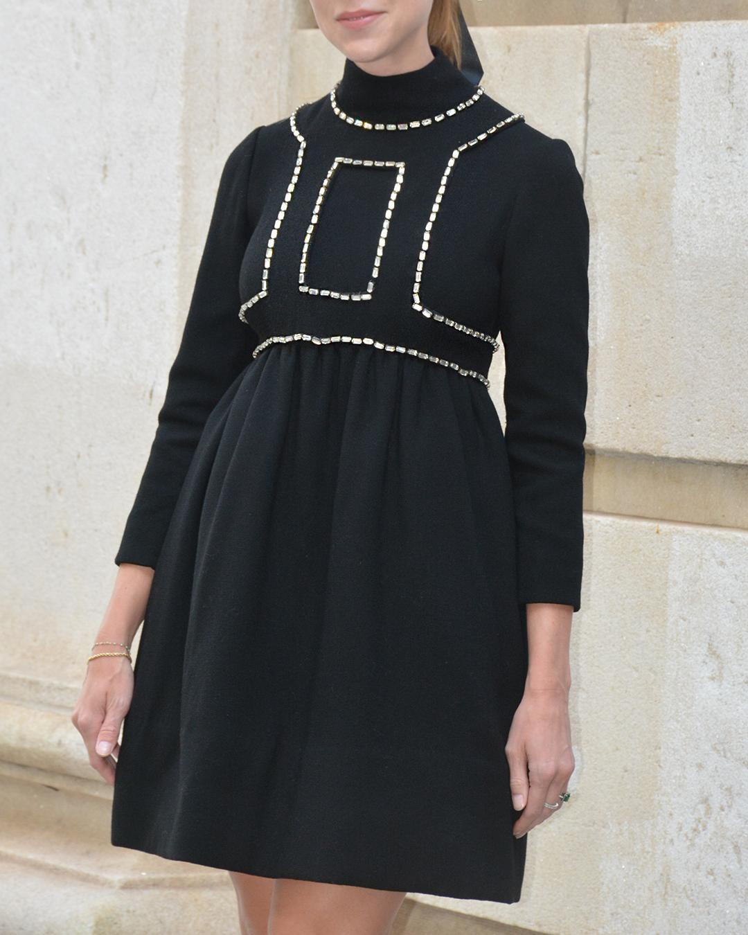 This very special vintage 1960s Donald Brooks dress is an iconic example midcentury fashion. Crafted of black wool, it features baguette-cut gems, which form a trompe l'oeil effect, almost like a harness or vest layered over the dress. The babydoll