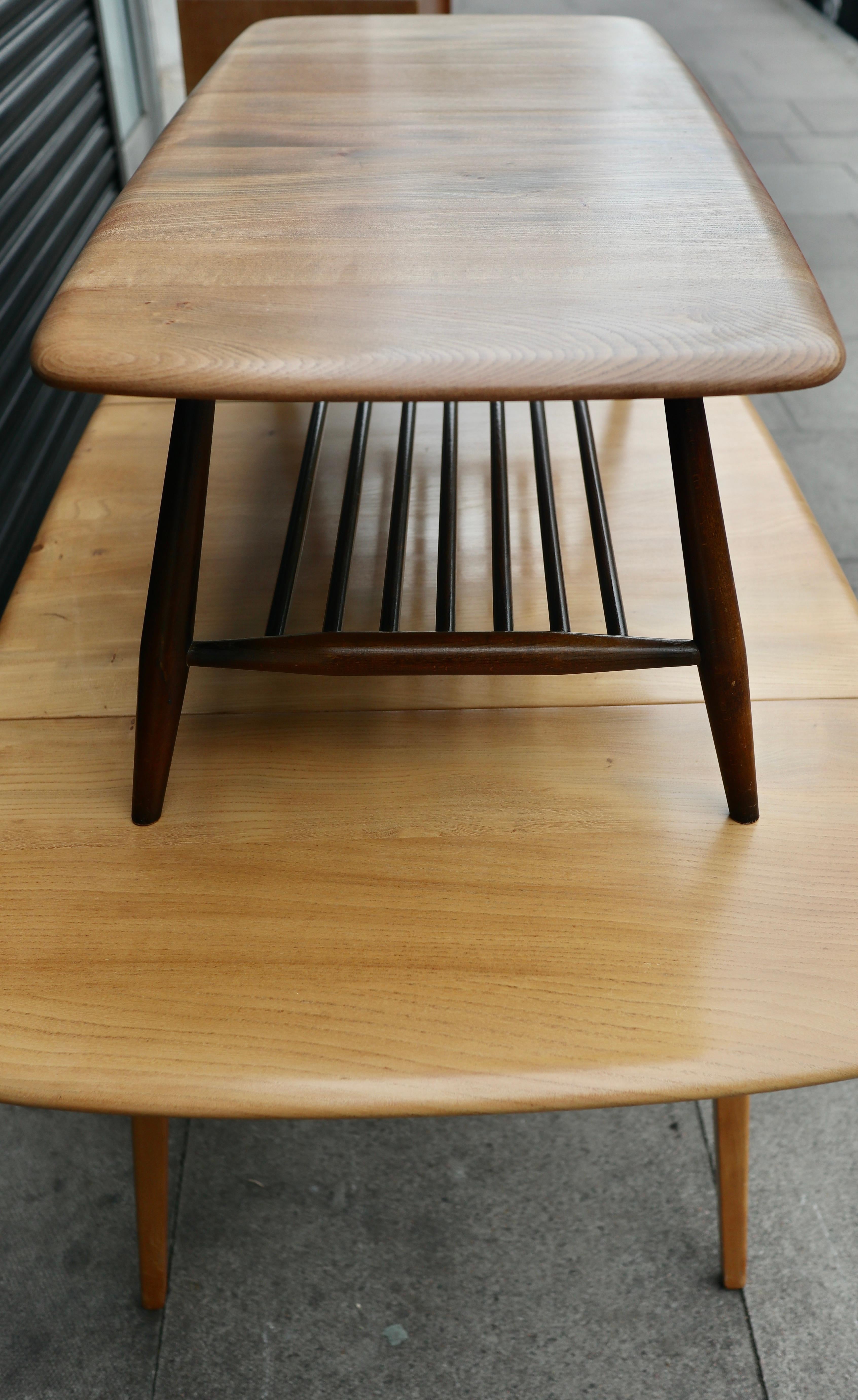 English Vintage 1960s  Ercol elm coffee table with magazine shelf   For Sale