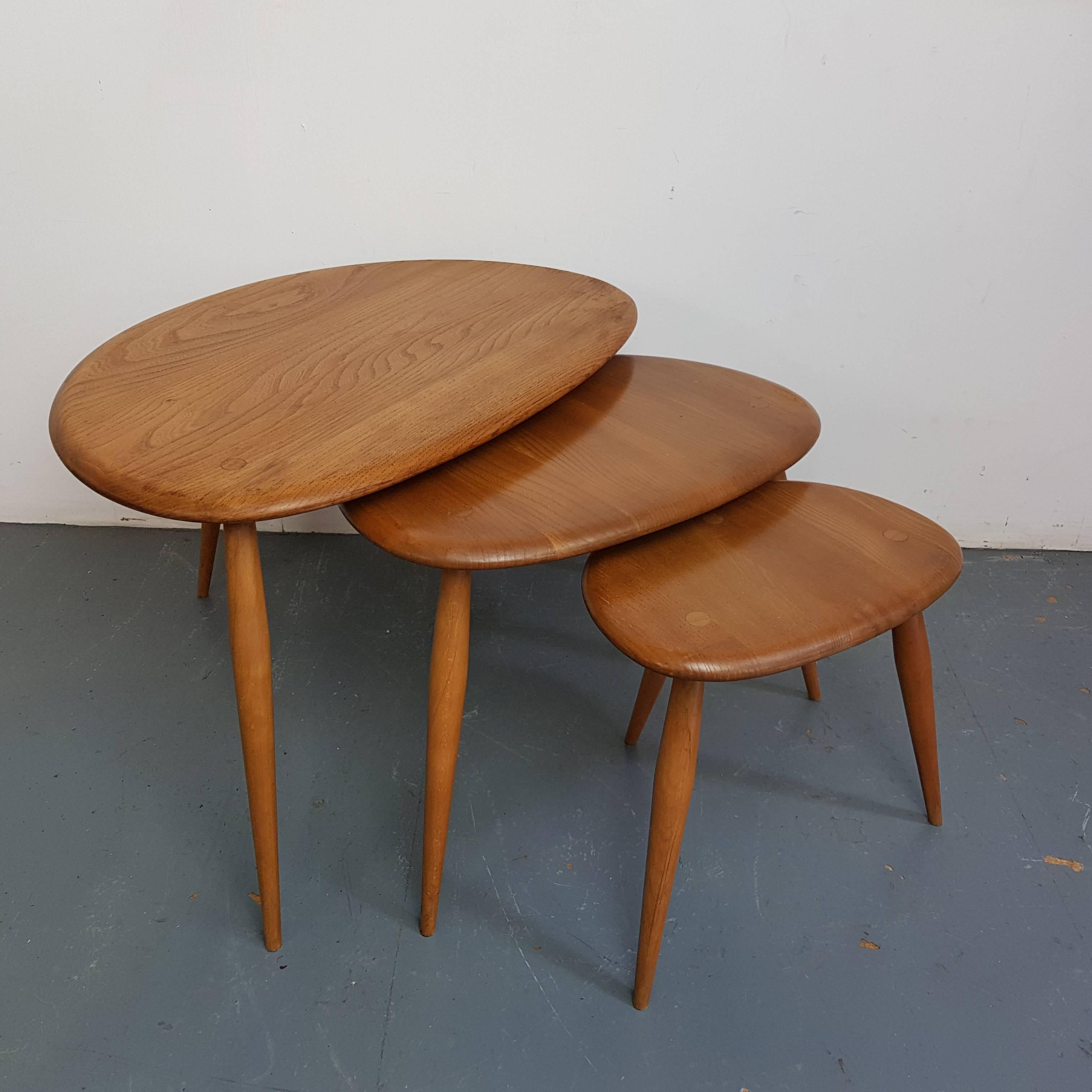 Designed by Lucian Ercolani 1956, these Ercol tables have a wonderful simplicity of design and appealing curves. Made with a beech top and splayed tapering legs. Lovely patina to the wood.

In good vintage condition, with some wear commensurate