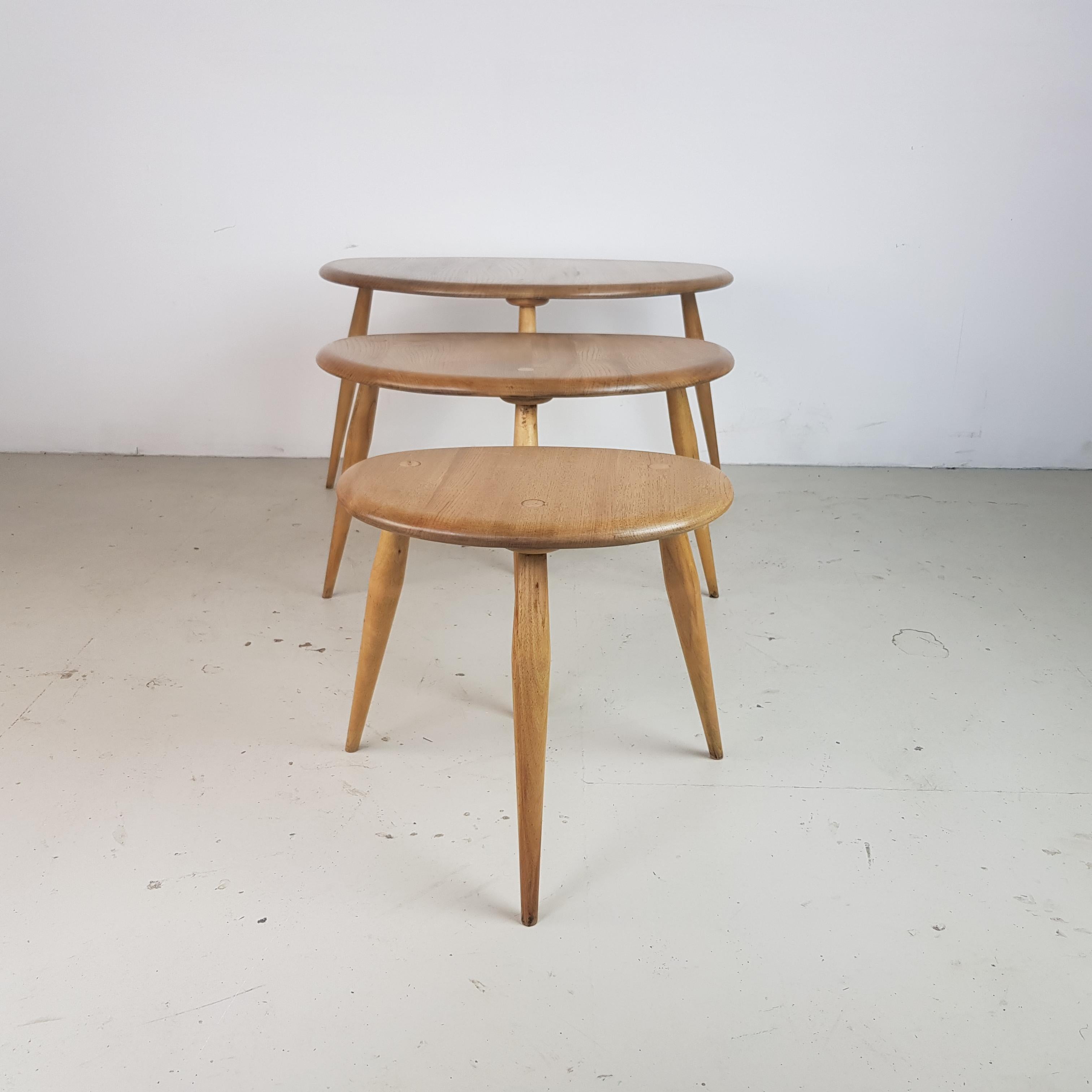 Designed by Lucian Ercolani 1956, these Ercol tables have a wonderful simplicity of design and appealing curves. Made with a beech top and splayed tapering legs. Lovely patina to the wood.

In good vintage condition, with some wear commensurate