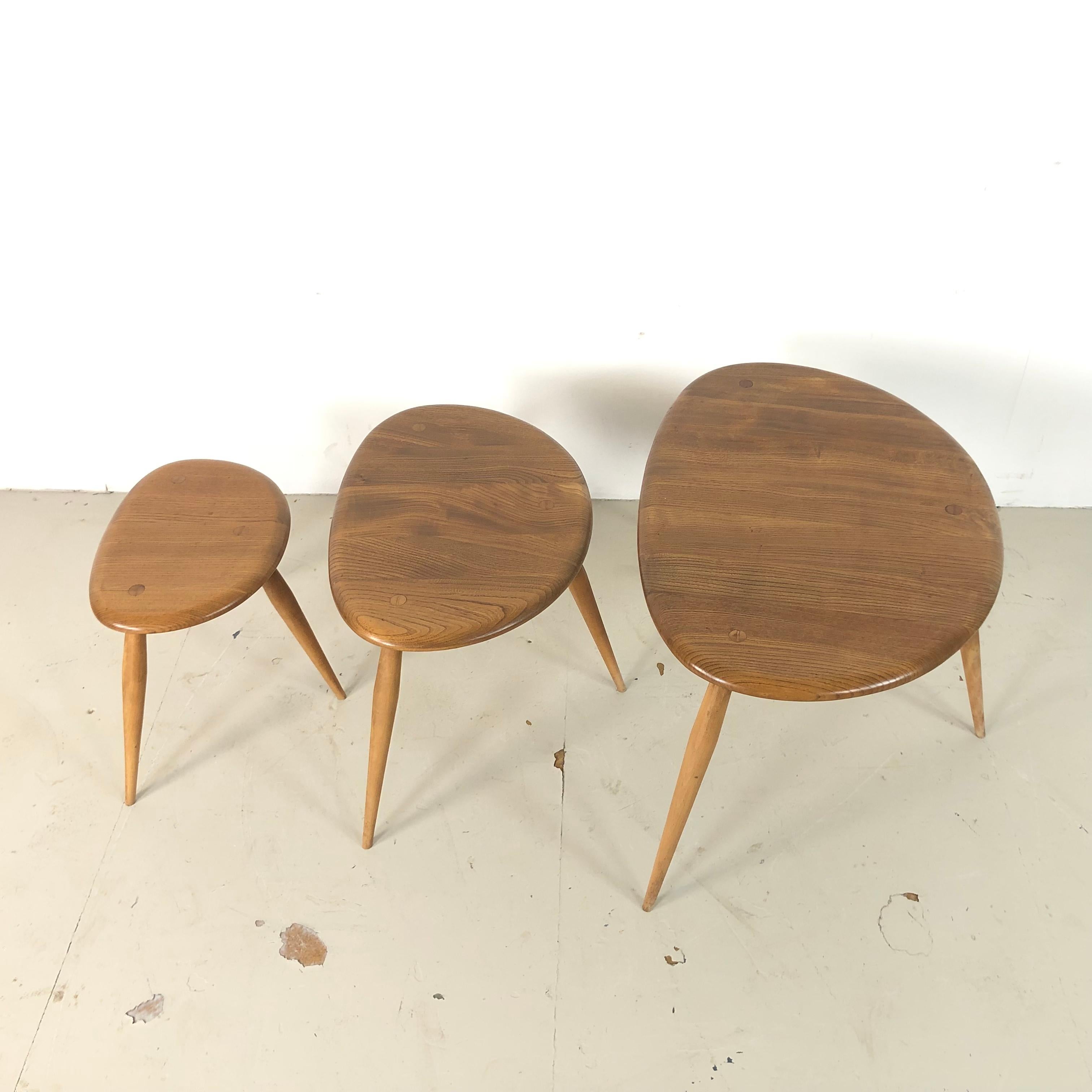 Designed by Lucian Ercolani 1956, these Ercol tables have a wonderful simplicity of design and appealing curves. Made with a beech top and splayed tapering legs. Lovely patina to the wood.

In good vintage condition, with some wear commensurate
