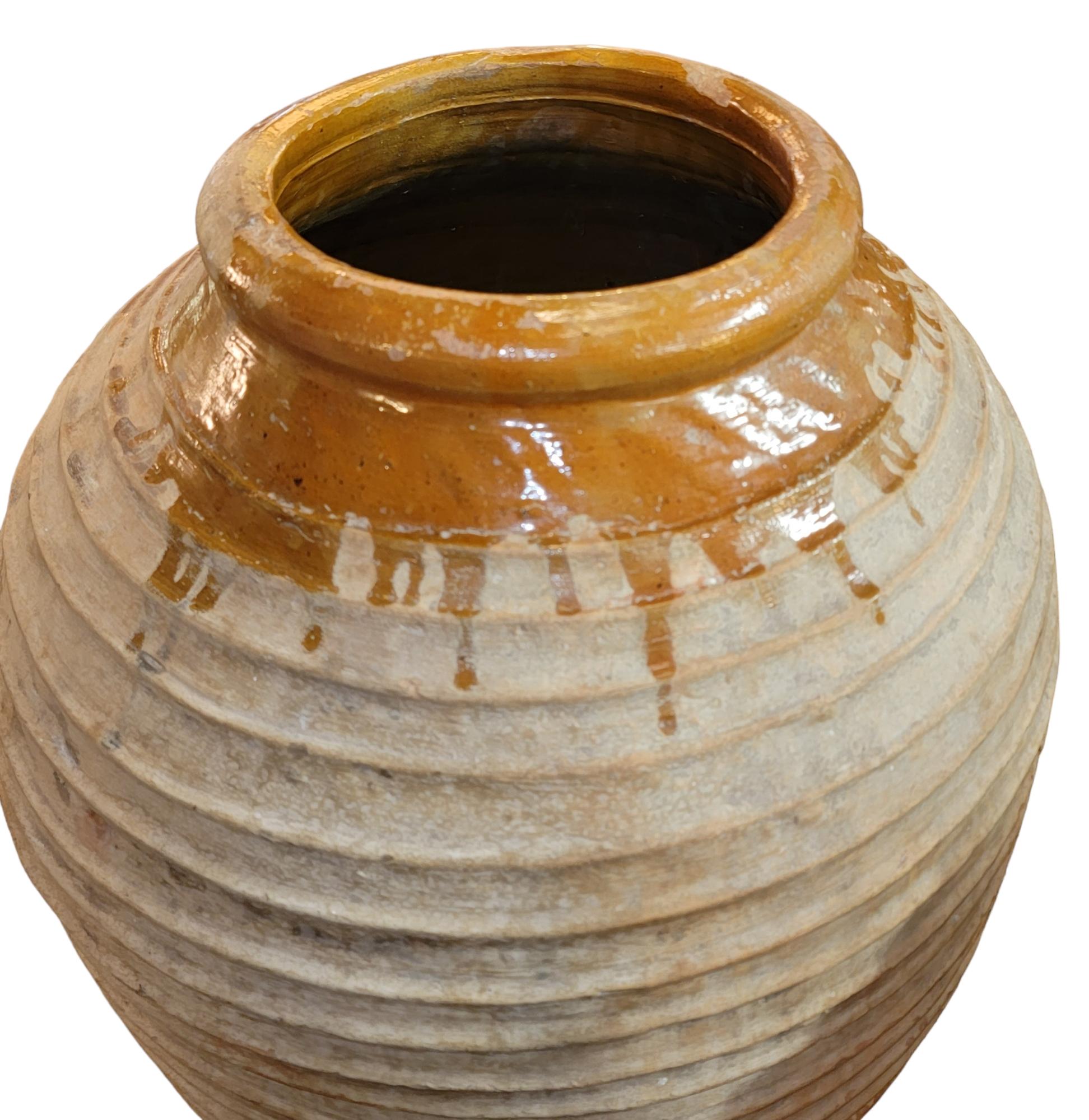 Wonderful colors in a vase. Natural with a honey color on the rim of the vase as to point out the it was a giant honey jar. The Honey paint drip on the rim is amazing and the natural color of the pottery has a wonderful texture that offers a great