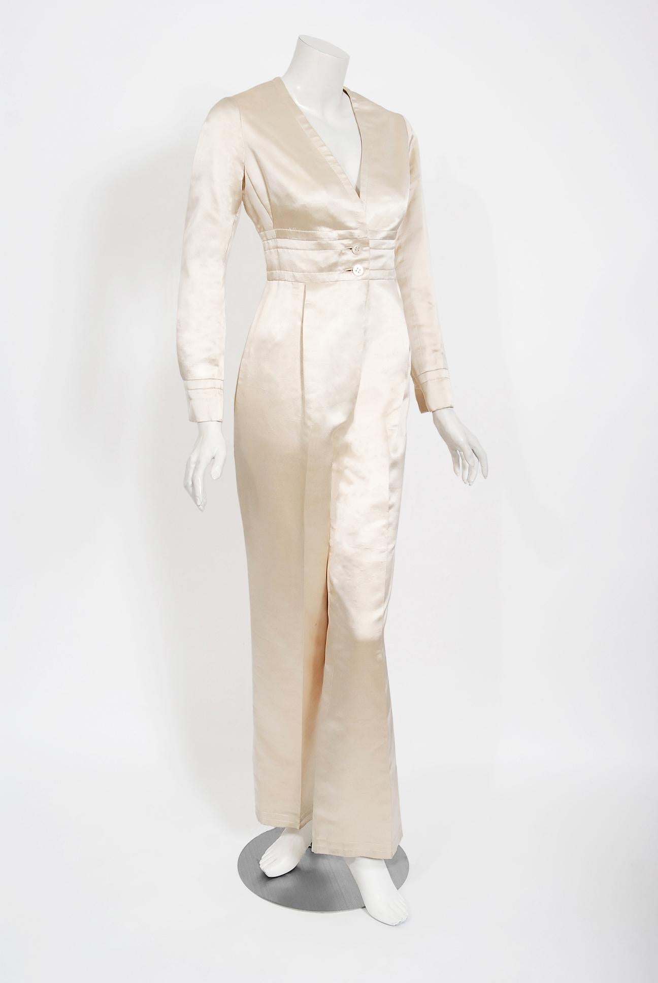 A gorgeous Galanos Couture ivory-creme silk satin jumpsuit dating back to the mid 1960's. Dedication to excellence in craftsmanship and design was the foundation of James Galanos' career. The quality of workmanship found in his clothing is