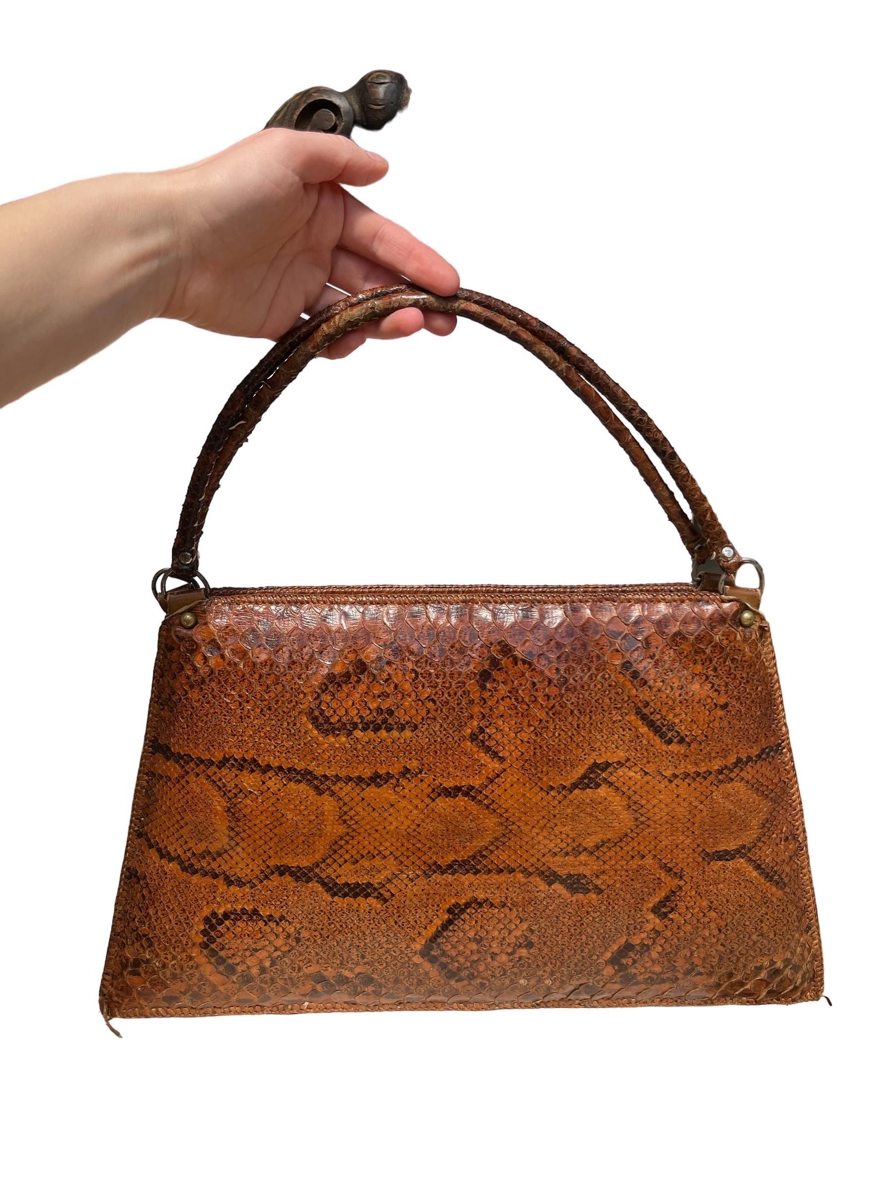 Large Vintage 1960s Genuine Snakeskin Purse 

Genuine vintage snakeskin top-handle handbag with leather interior. Made & originally purchased in Sudan circa 1960s. Zipper works great, can hold quite a lot for with its size. Excellent condition for