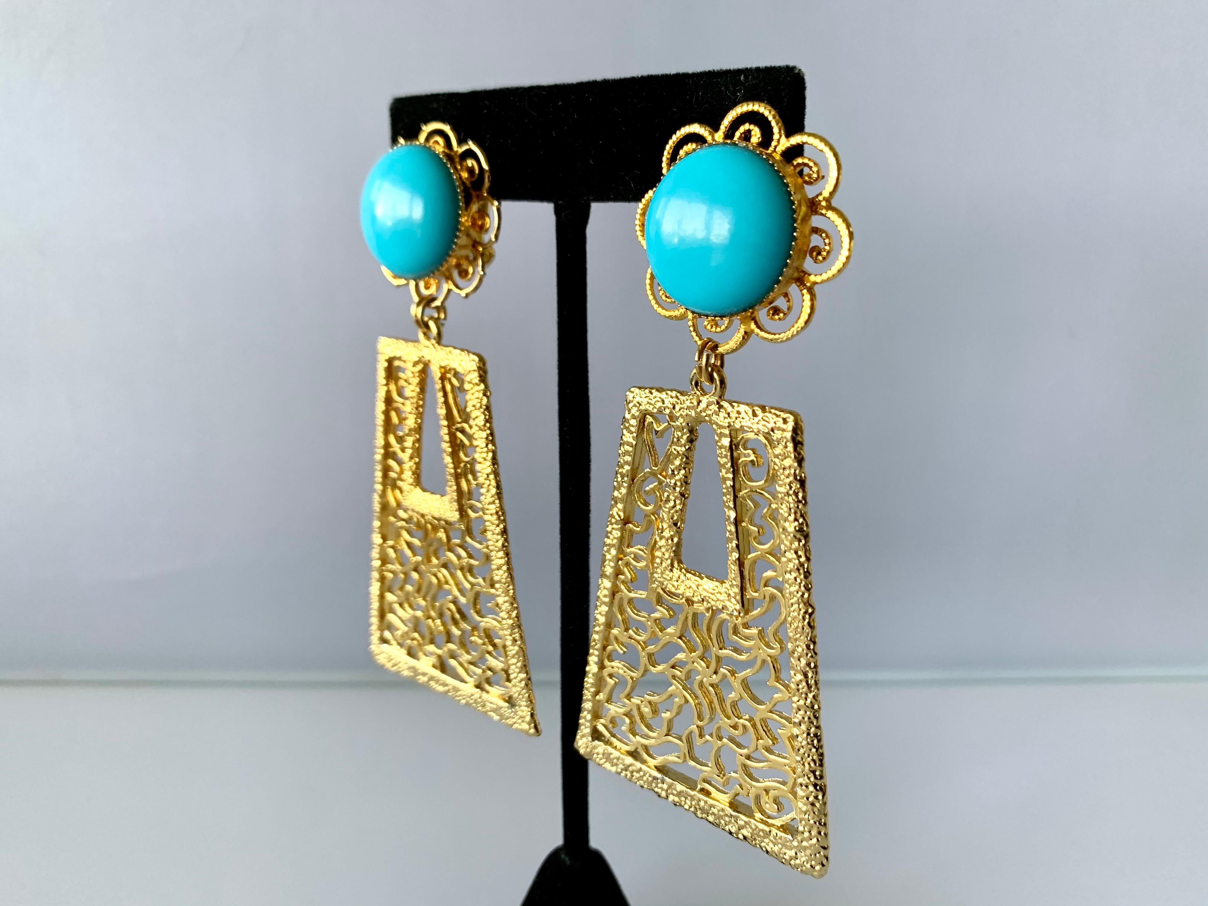 Vintage oversized 1960's geometric statement clip-on earrings comprised out of gold-tone metal adorned by large faux turquoise cabochons - designed by William de Lillo.