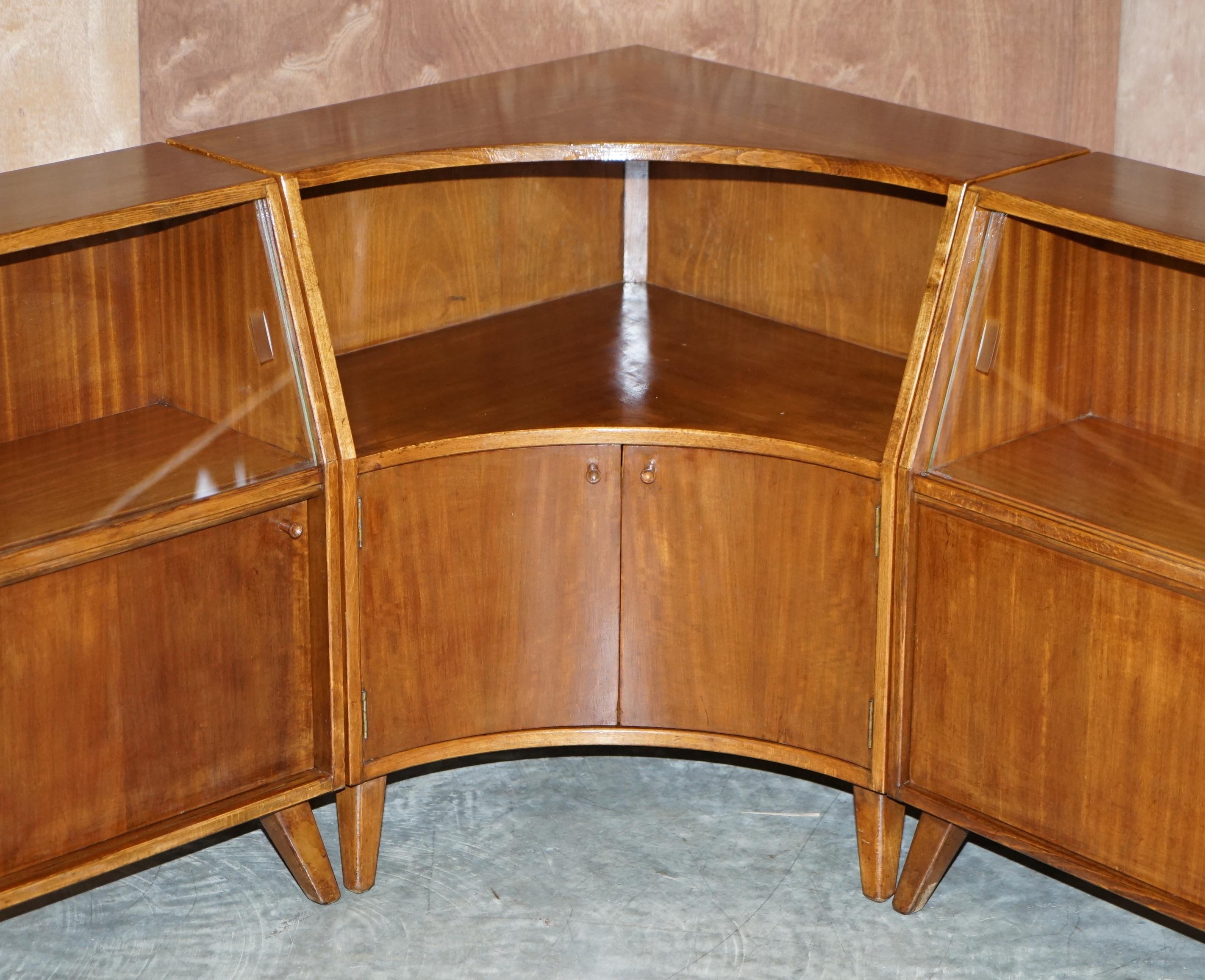 We are delighted to offer for this lovely lightly mahogany with glass sliding doors Greaves & Thomas Put-U-Up modular sideboard

A very charming and finely made suite of Mid-Century Modern sideboards. These are modular as mentioned so you can use