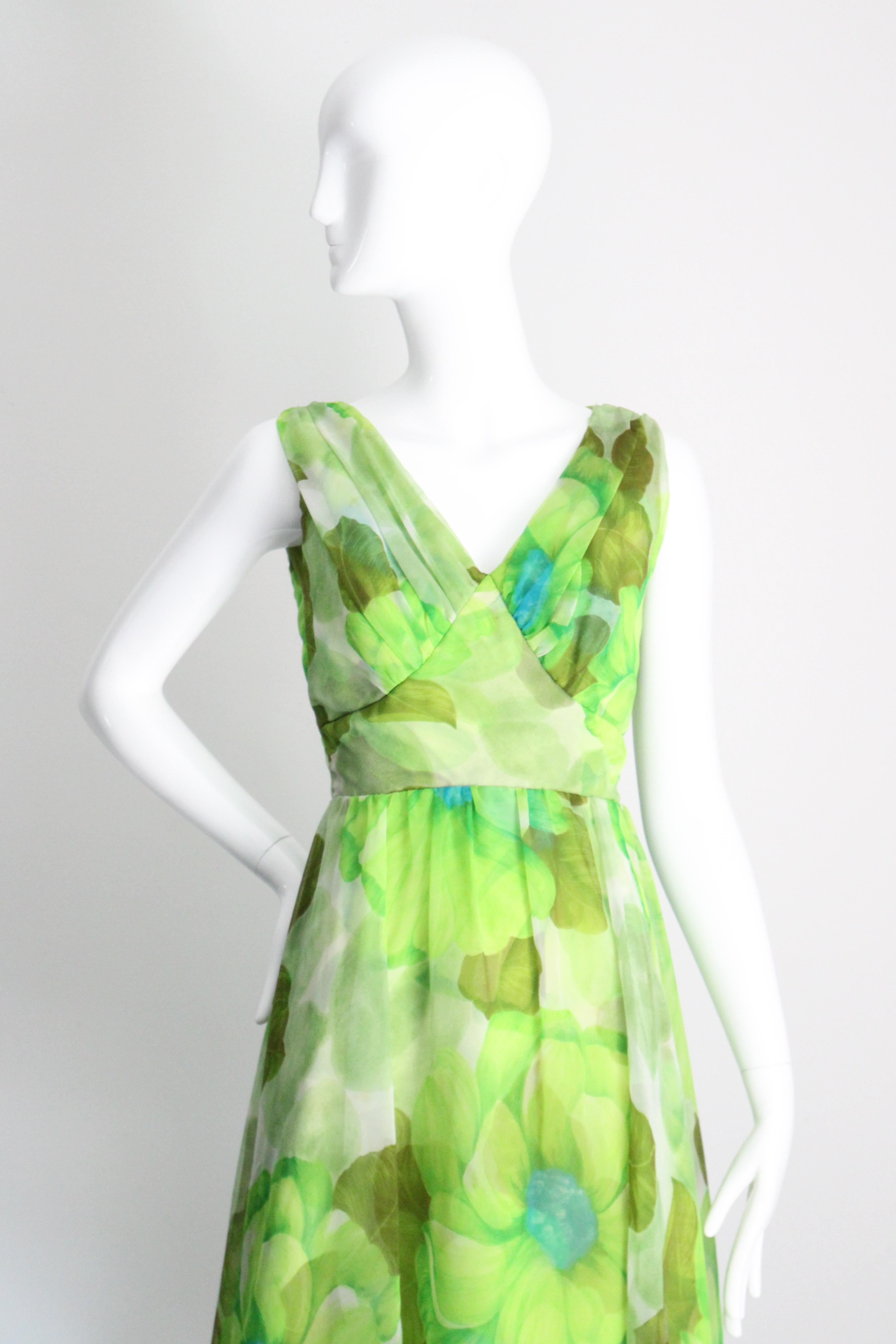 Rendered in the brightest palette of greens with turquoise blue and cream accents in a bold flower and leaf pattern, this original vintage 1960's chiffon dress and coat ensemble, is the perfect set to add versatility to your vintage wardrobe.

The V