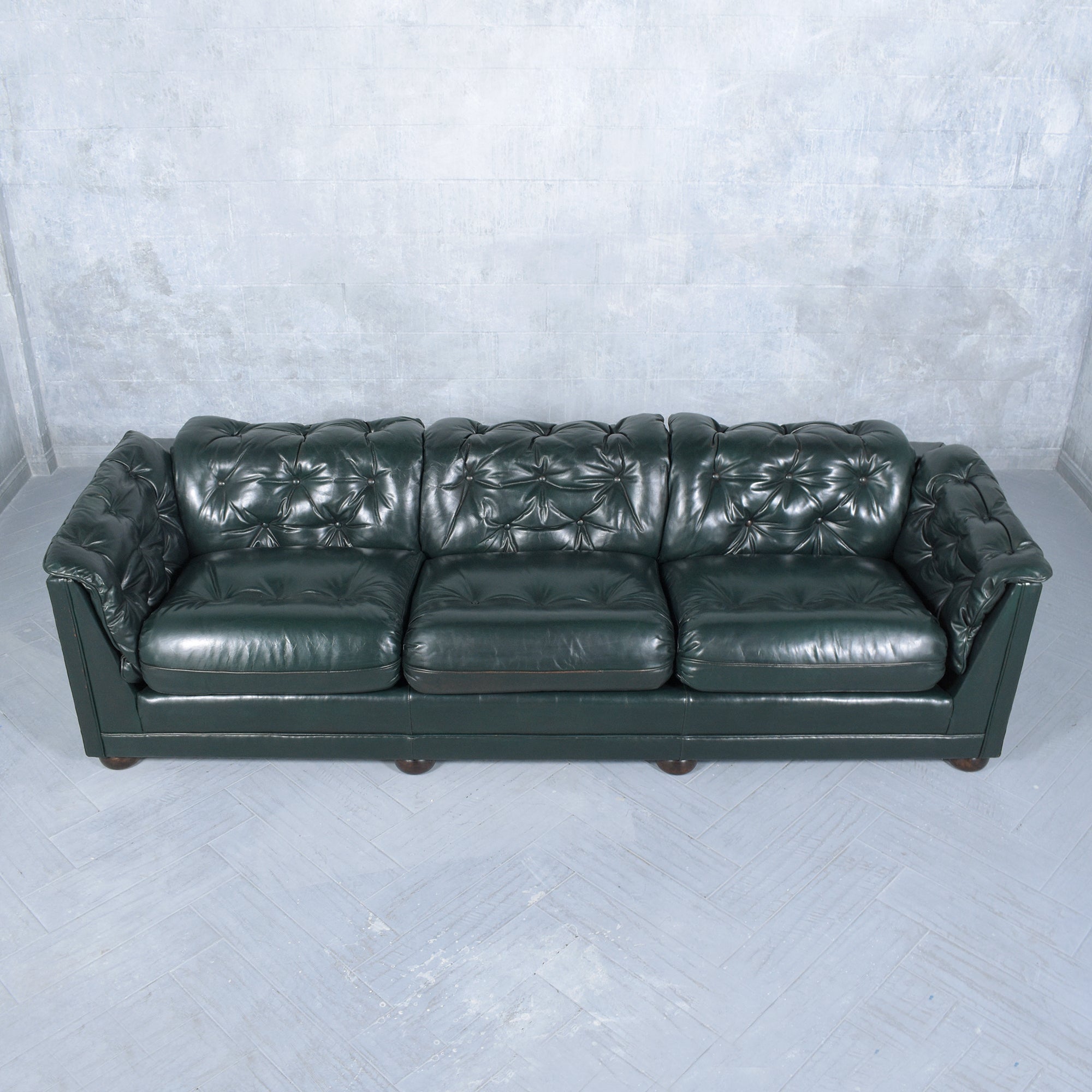 Experience the pinnacle of luxury with our 1960s Vintage Emerald Green Chesterfield Leather Sofa, embodying timeless elegance and superior craftsmanship. Handcrafted with a robust solid wood frame, this sofa is adorned in its authentic leather,