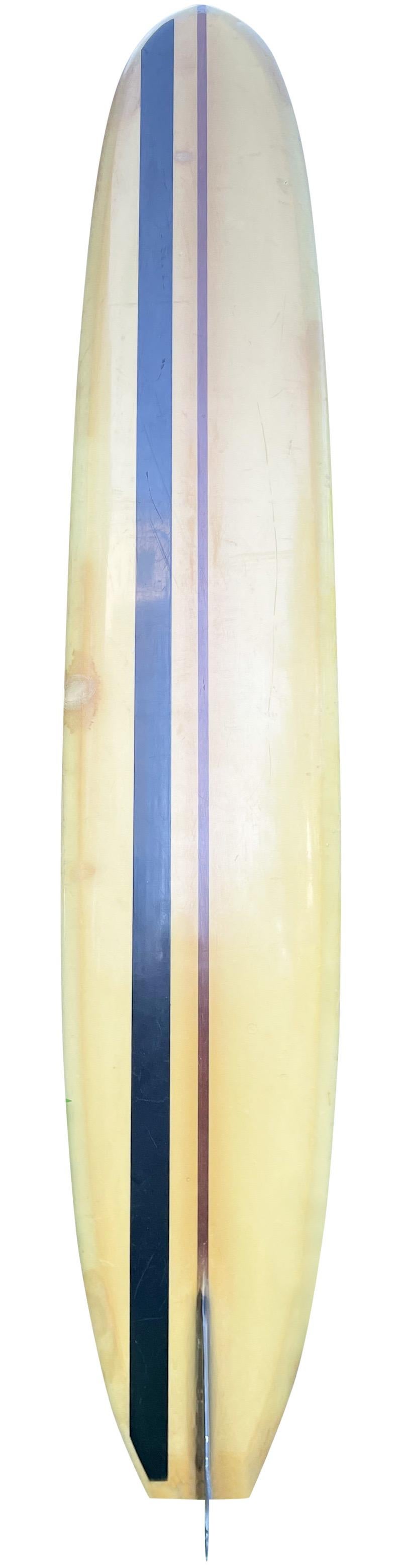 Early-mid 1960s Greg Noll custom longboard. Features a single redwood stringer design with wood tailblock. Black resin stripe with complimentary black single fin. Hand signed by Greg Noll in 1999. One of the most acclaimed big wave surfing legends