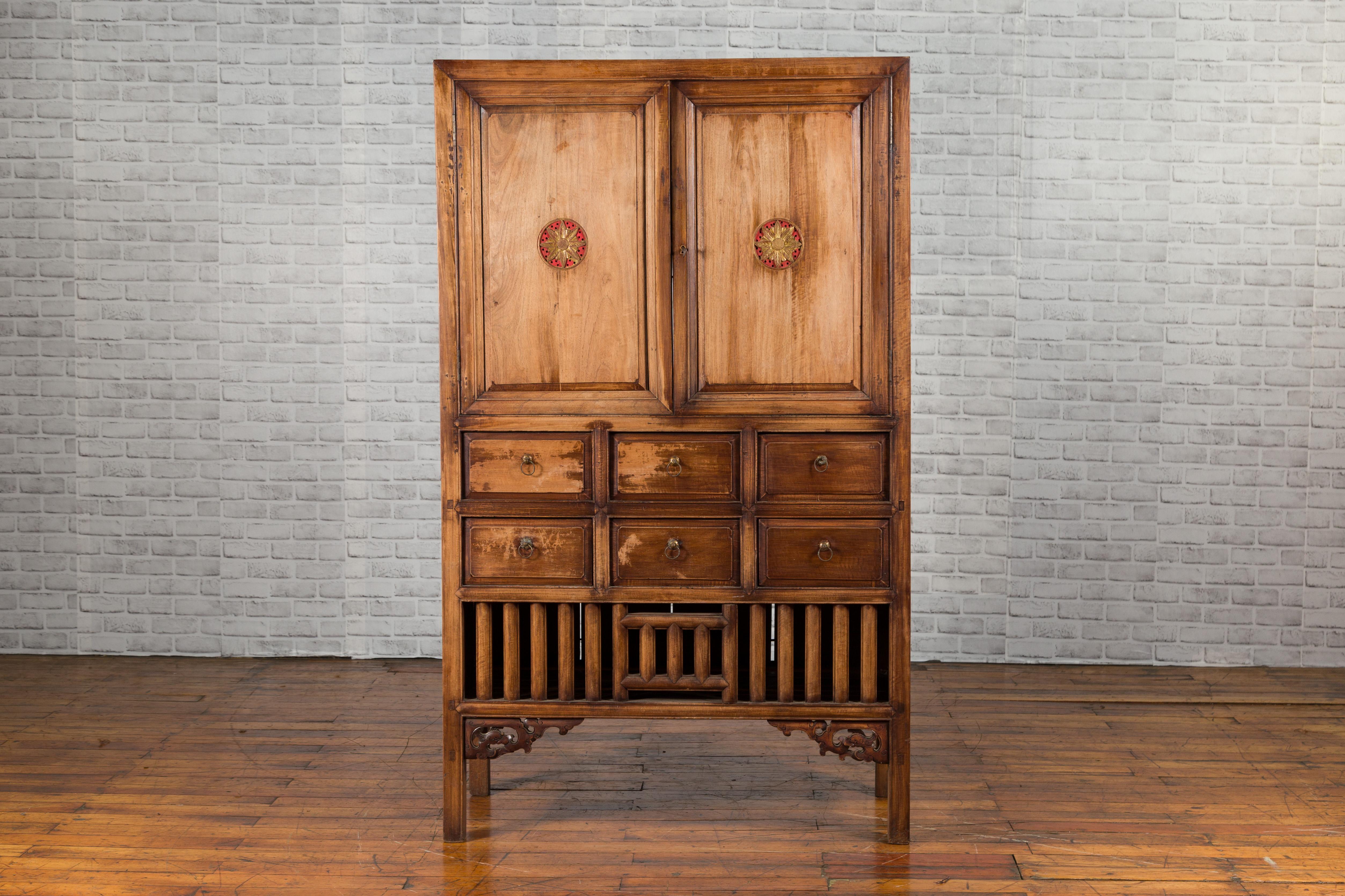 A vintage Taiwanese hand-carved and hand-painted armoire from the mid-20th century, with two doors, six drawers and floral motifs. Created during the 1960s in Taiwan, this hand-carved wooden armoire features a linear silhouette. The upper section