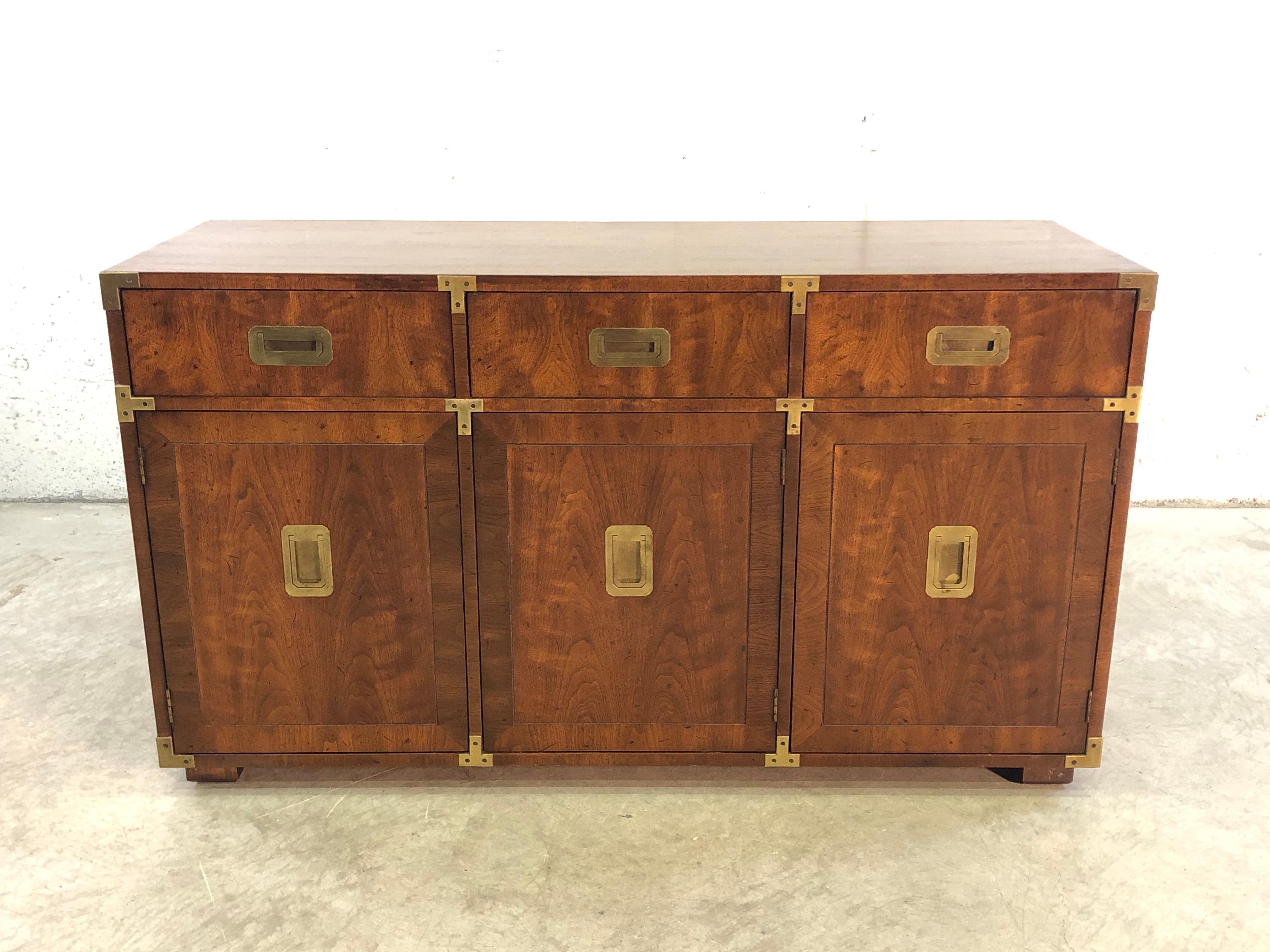 Vintage 1960s Henredon Funiture Campaign style buffet sideboard dining room server. The server has a lot of storage with three drawers on top and shelf storage on the bottom. Great brass accents and in excellent condition.